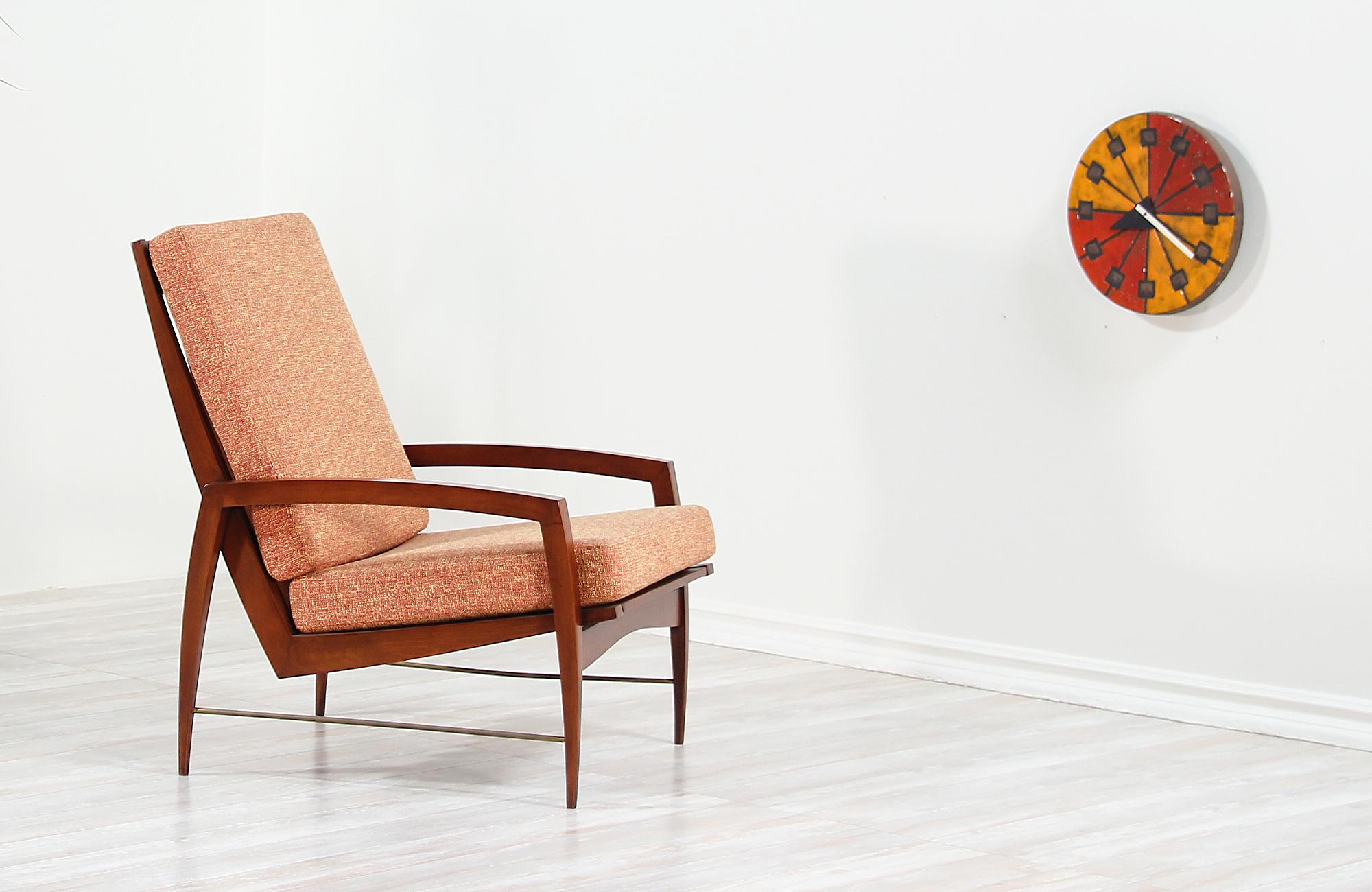 High-back lounge chair designed and manufactured in Denmark, circa 1960s. Featuring a beautifully carved walnut wood frame with five slats accentuating the high-back with curvilinear legs and arms that create an elegant structure. The cushions are