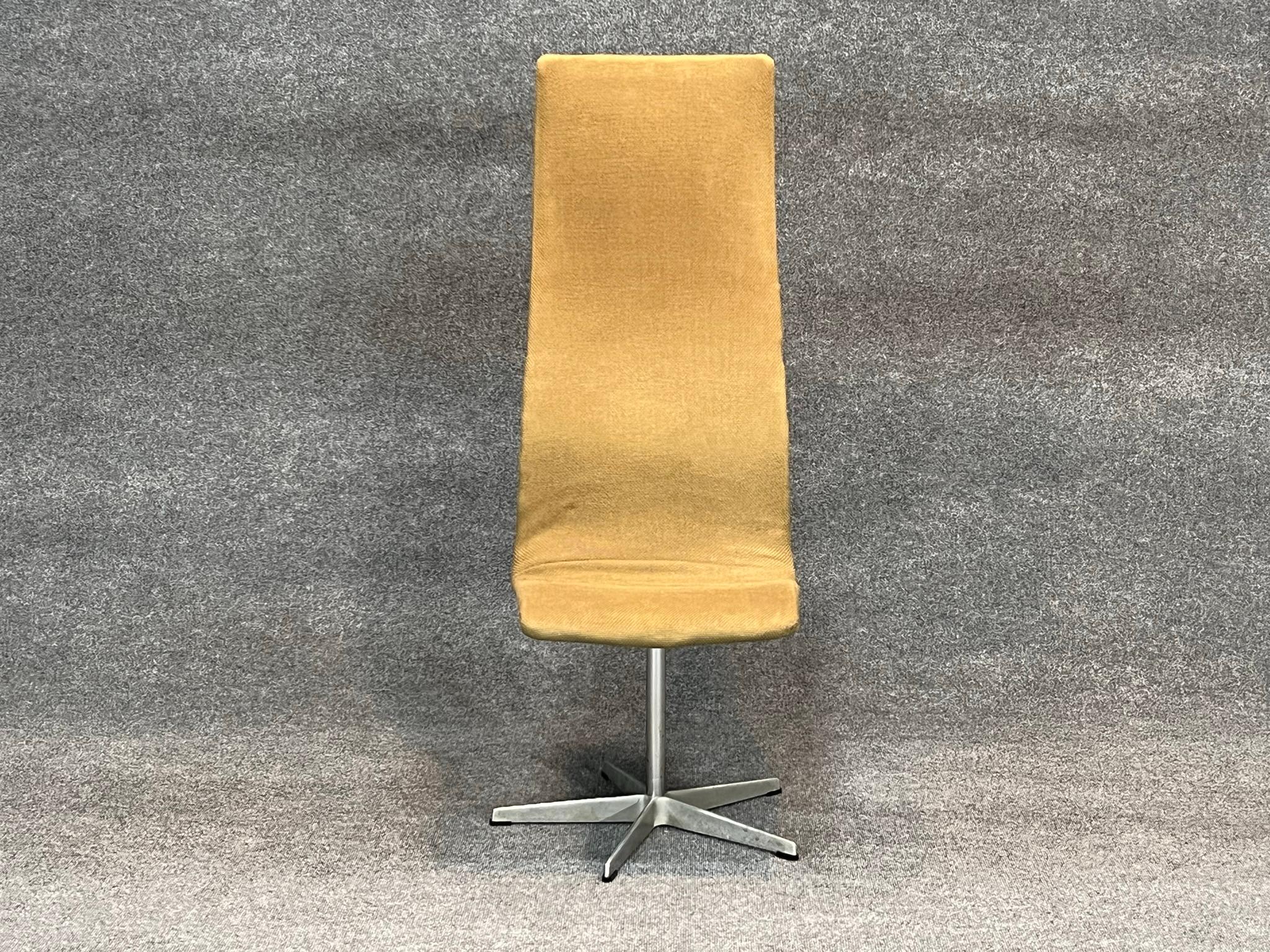 Arne Jacobsen for Fritz Hansen, 'Oxford' high backed desk chair, aluminum, wood, fabric upholstery, United Kingdom, design 1965, recent production.

The original version of the 'Oxford' chair was designed for the professors at St. Catherine’s