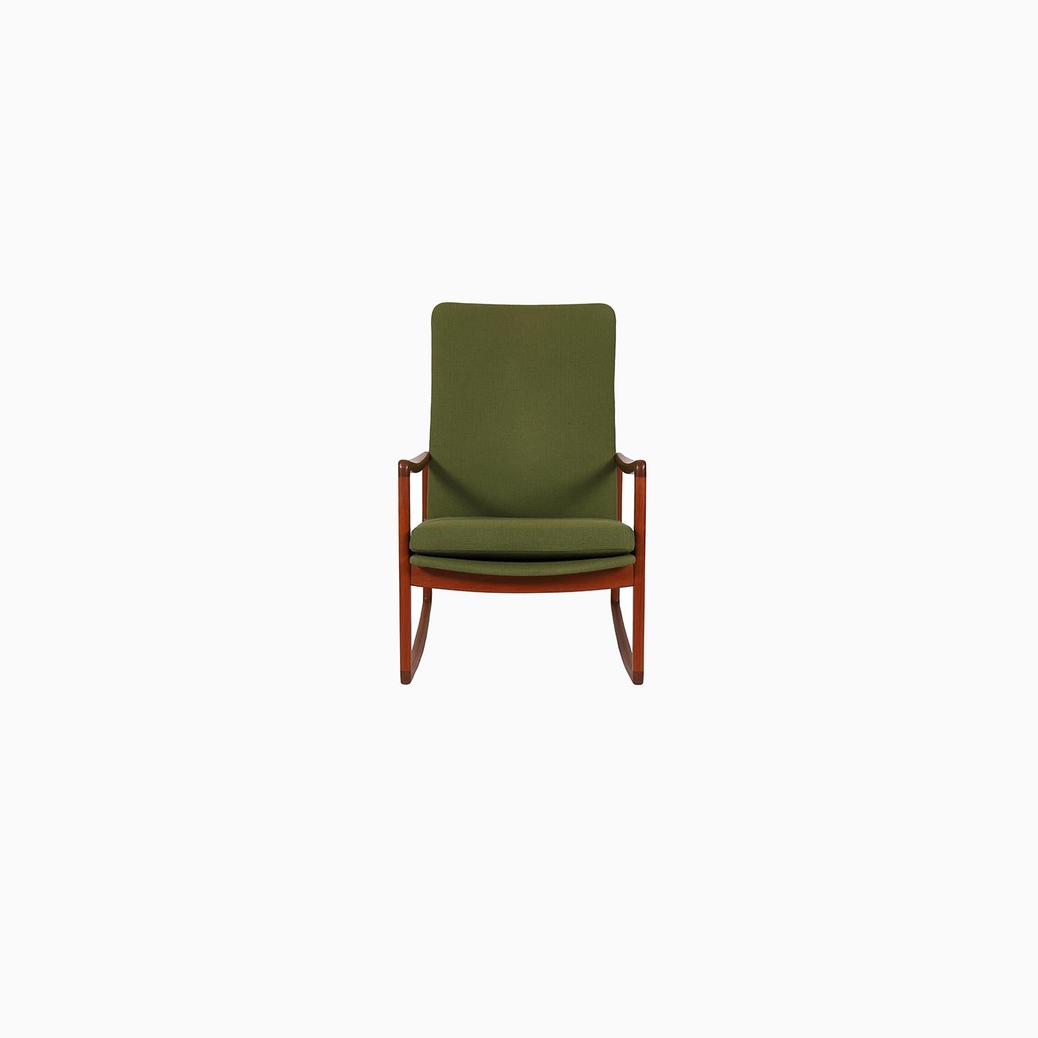 This high backed rocking chair has integrated cushions + a loose seat cushion in original green wool upholstery.  Designed by Ole Wanscher-- who is known for the elegance of his designs which utilize retrained curve and delicacy in divine balance.