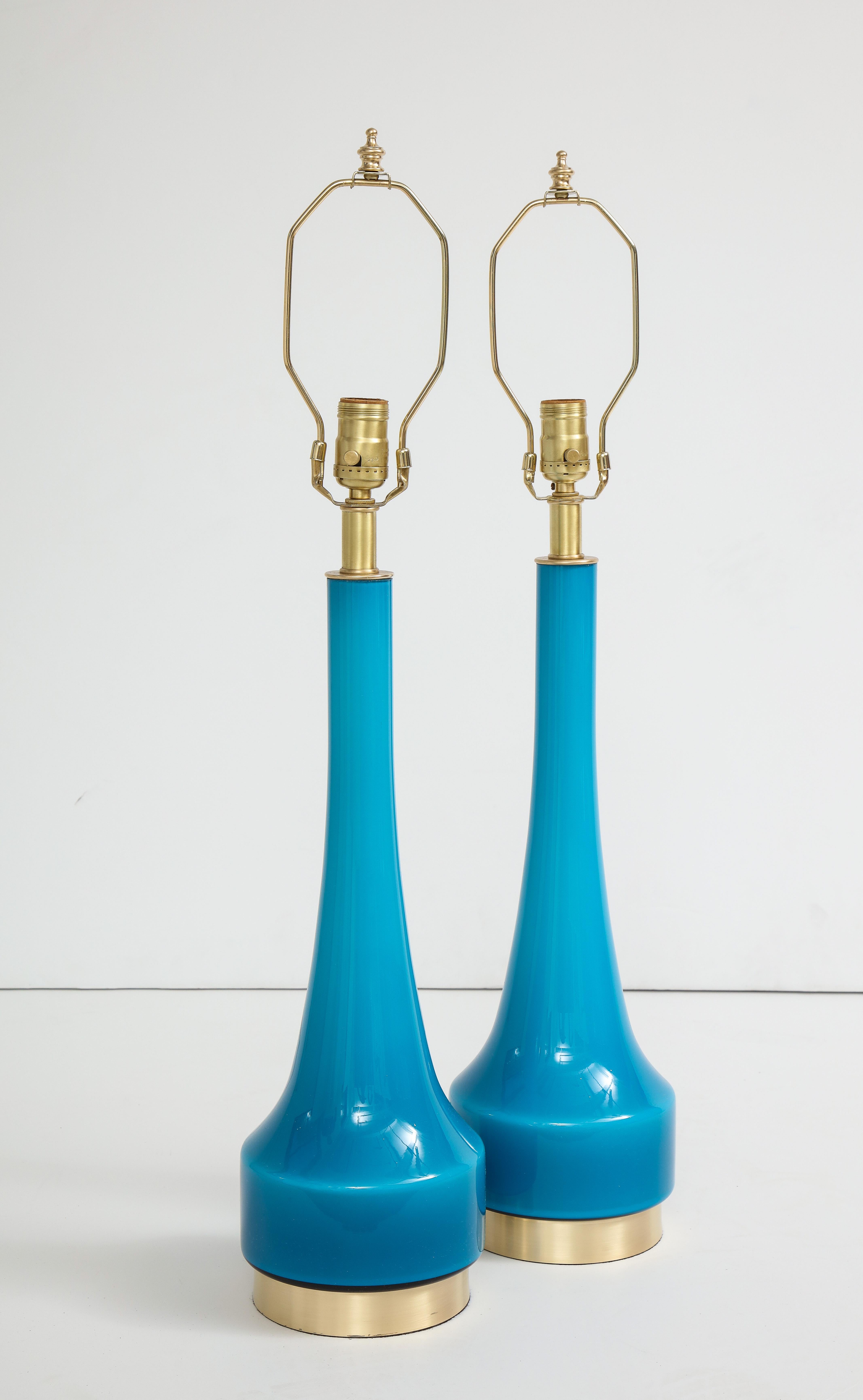 Pair of deep cerulean blue hand blown glass lamps on satin brass bases by Holmegaard. Rewired for use in the USA, 100W max.