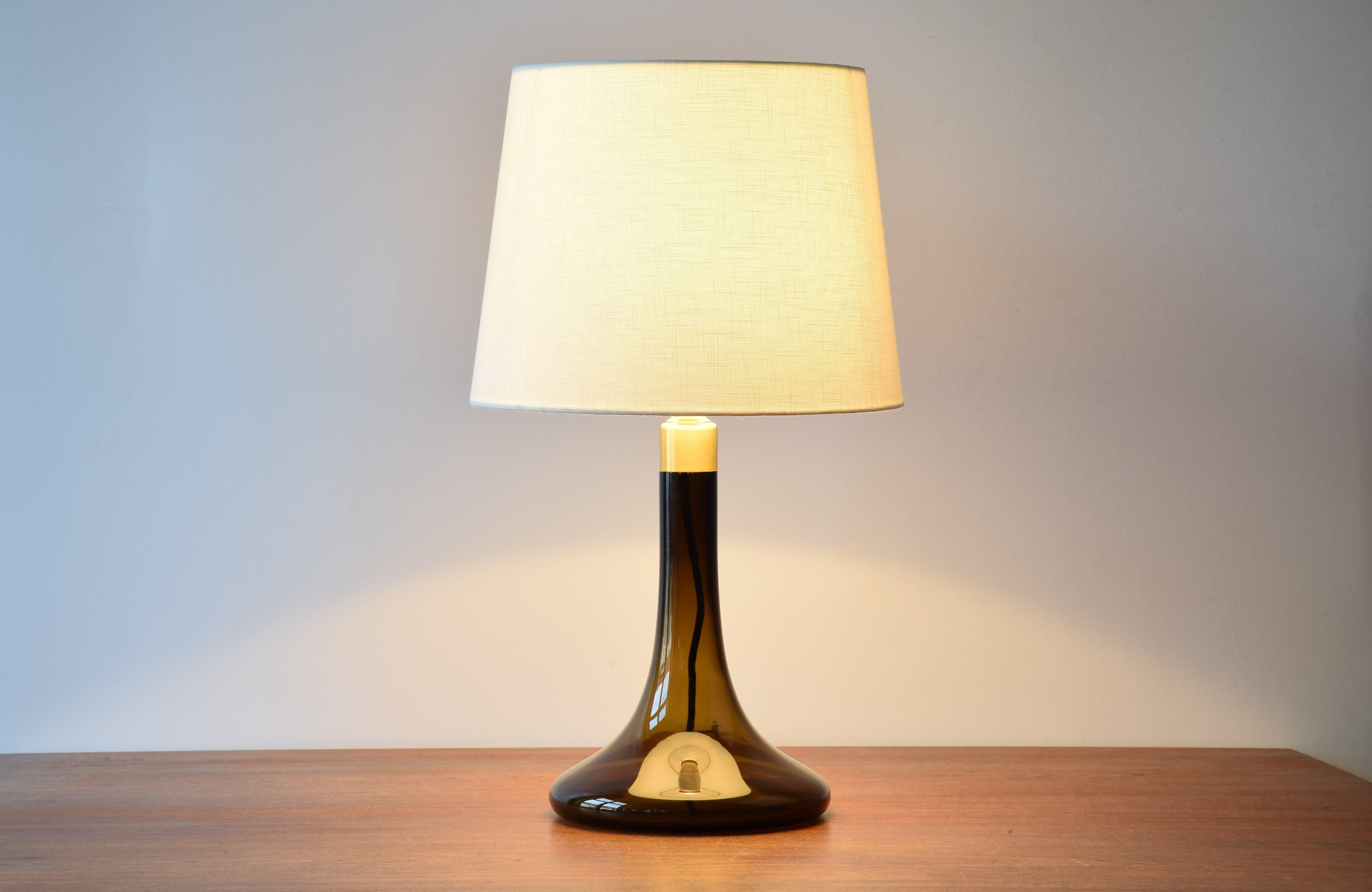 Mid-century glass table lamp model Havanna designed by Poul Christiansen for Holmegaard and Le Klint in 1979. 

The lamp is made of brown transparent glass and has a metal top, most likely made of brass.

Included is a new lampshade designed in