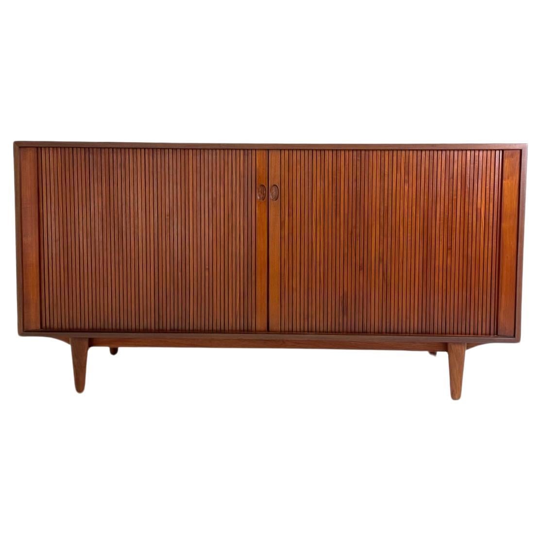 Ib Kofod-Larsen for J. Clausen Brande Møbelfabrik Danish Modern Teak Credenza with Tambour Doors. Designed in the 1960s in Denmark by a master craftsman, IB Kofod Larsen, this tambour door credenza slides open smoothly to reveal 2 drawers on the