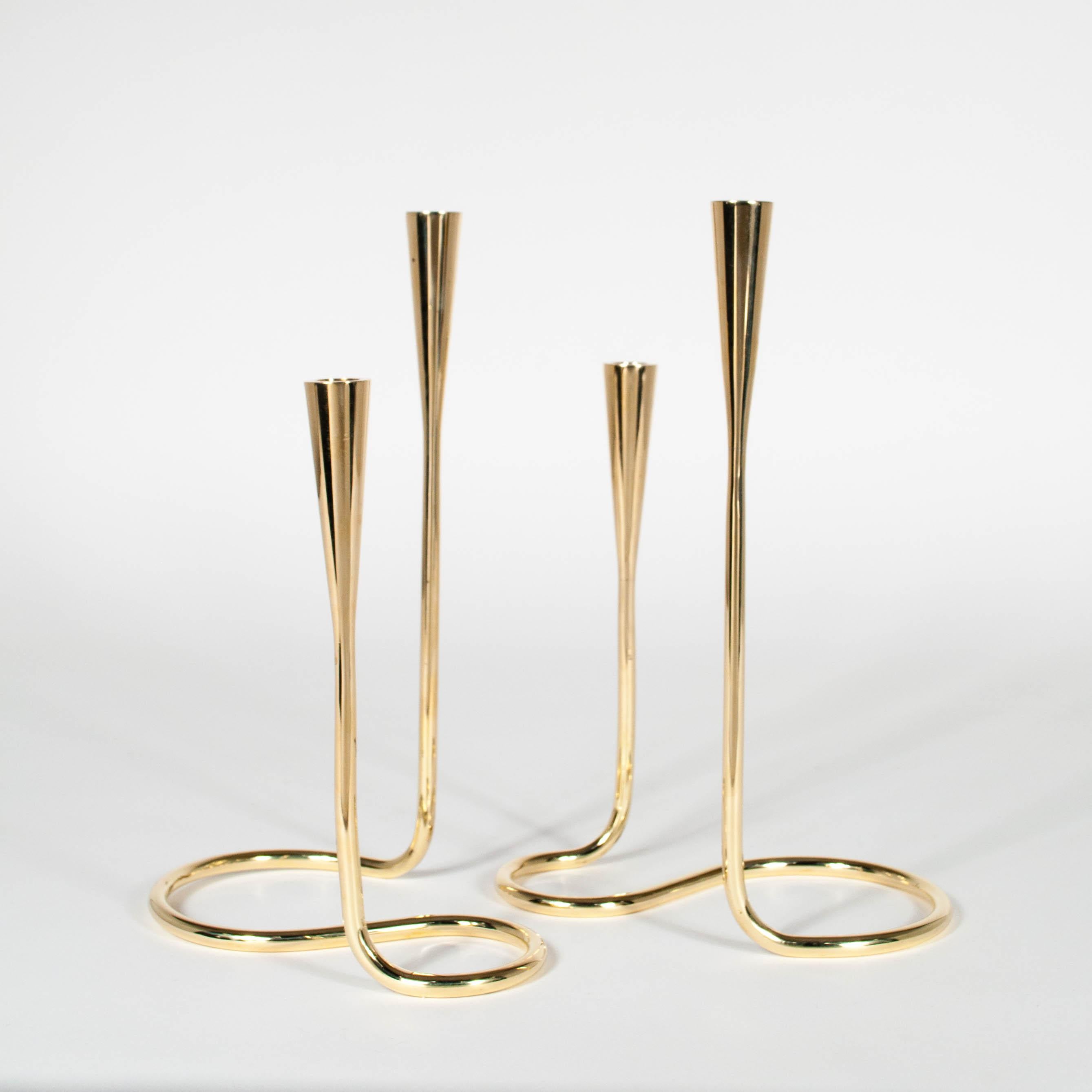 Stunning pair of midcentury Danish serpentine brass candlesticks by Illums Bolighus. Each are stamped underneath. Designed to accommodate slim 1/2” candles. Newly polished to a high shine.
 