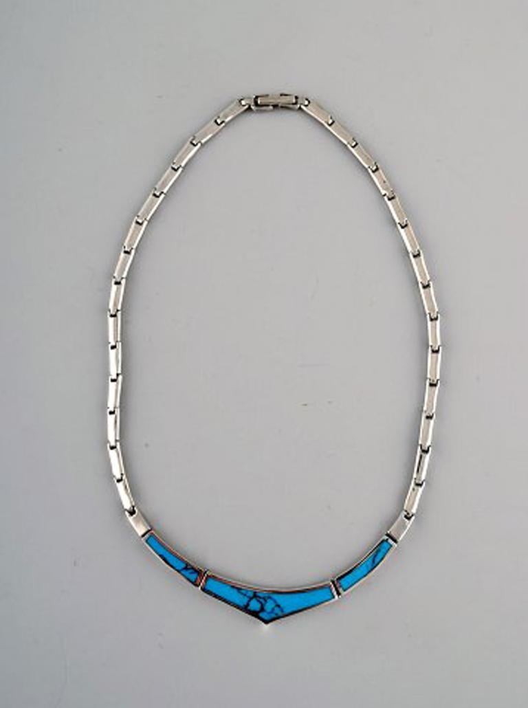 Danish modern jewelry set in sterling silver. 1960/70's. Comprising of necklace, ring and pendant with turquoise.
In very good condition.
Stamped.
The ring measures: 20mm US size: 9,75. The pendant measures: 20 x 17 cm. Necklace total length: 41
