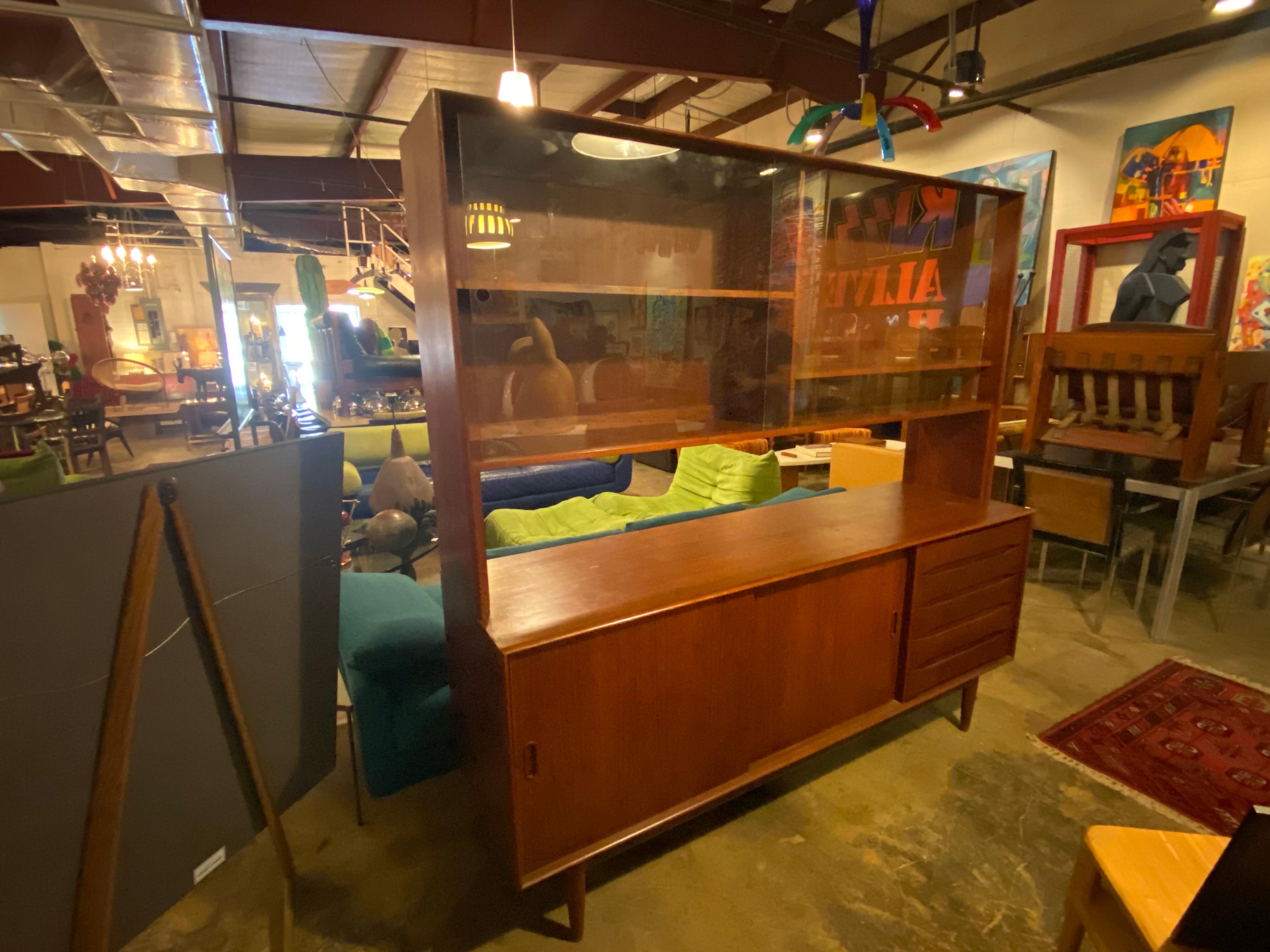 Beautifully crafted Danish modern sideboard with a removable hutch made of teak and is finished on the back allowing this piece to float. This piece offers plenty of storage and is in great overall condition with wear mostly on the top and side
