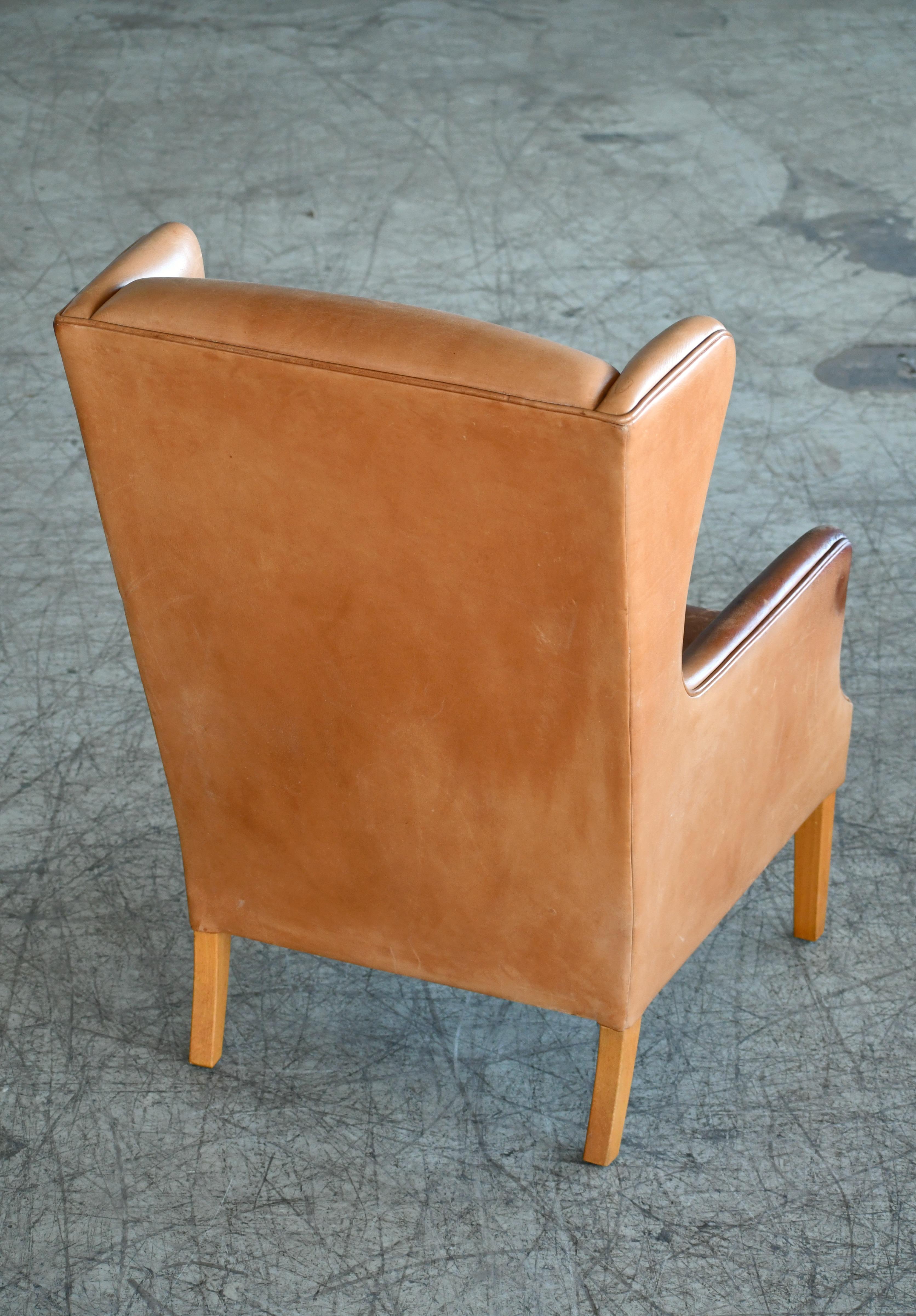 Mid-20th Century Danish Modern Kaare Klint Style Wingback Chair in Tan Leather with Patina