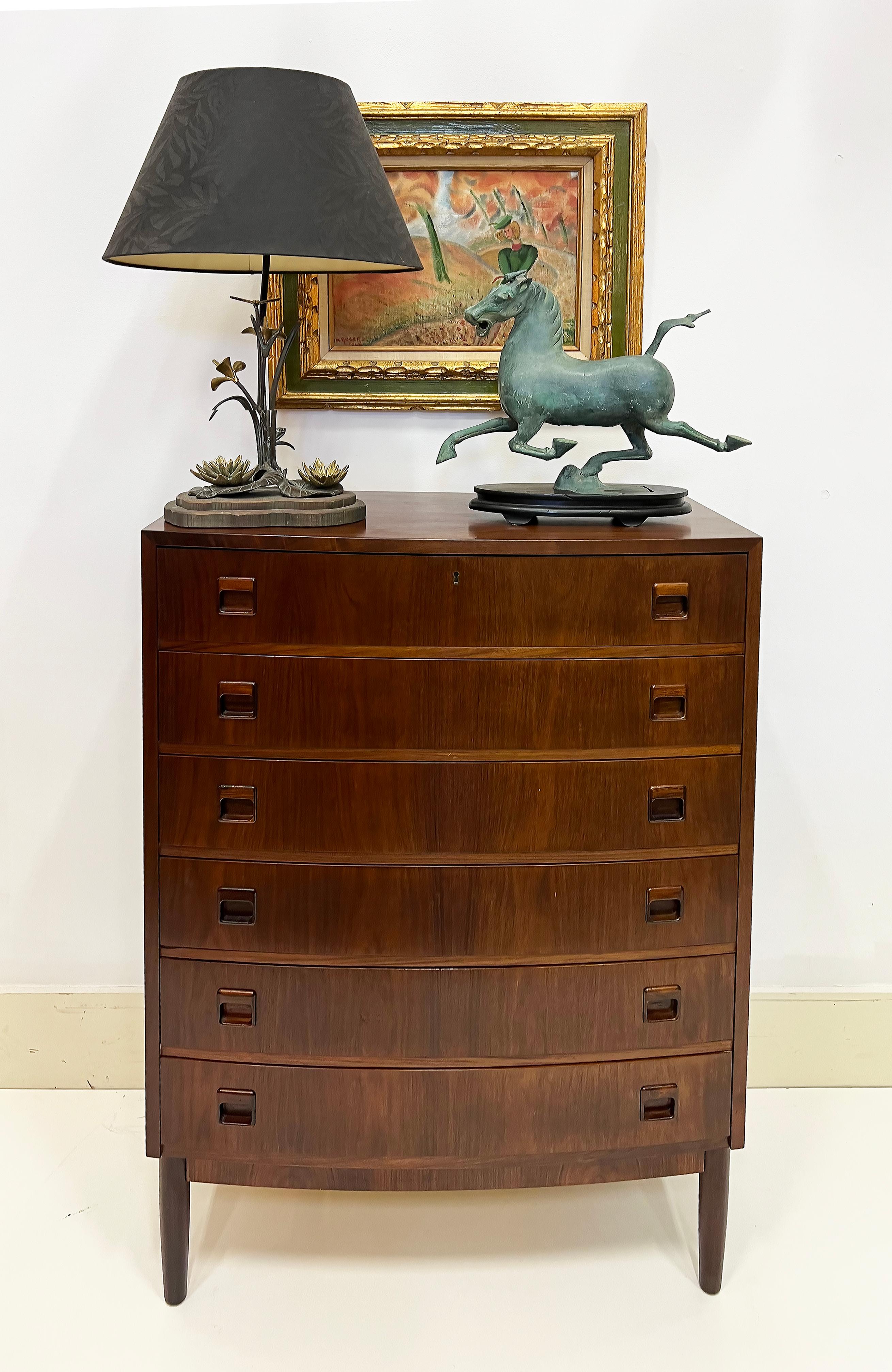 Danish Modern Kai Kristiansen Brazilian Rosewood Tall Chest of Drawers

Offered for sale is a vintage Danish Modern tall or high chest of drawers by Kai Kristiansen with a slight bow front. The chest is made with beautifully grained Brazilian