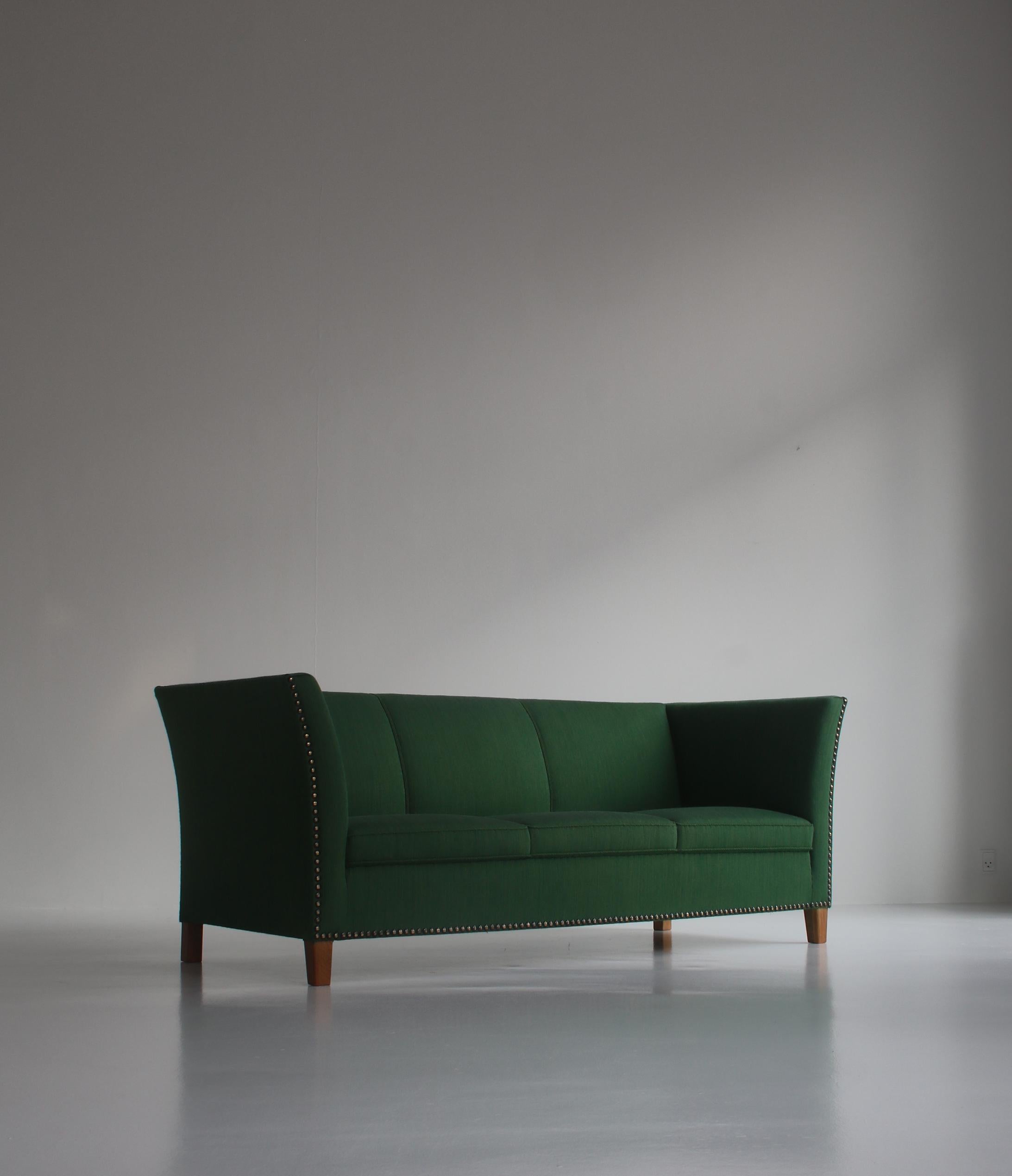 Wonderful and rare 3-seater sofa designed by Kaj Gottlob in the 1940s and made at master cabinetmaker A.J. Iversen. The sofa is upholstered in the original green wool with brass nails and the legs are made from solid oak. Good original condition.