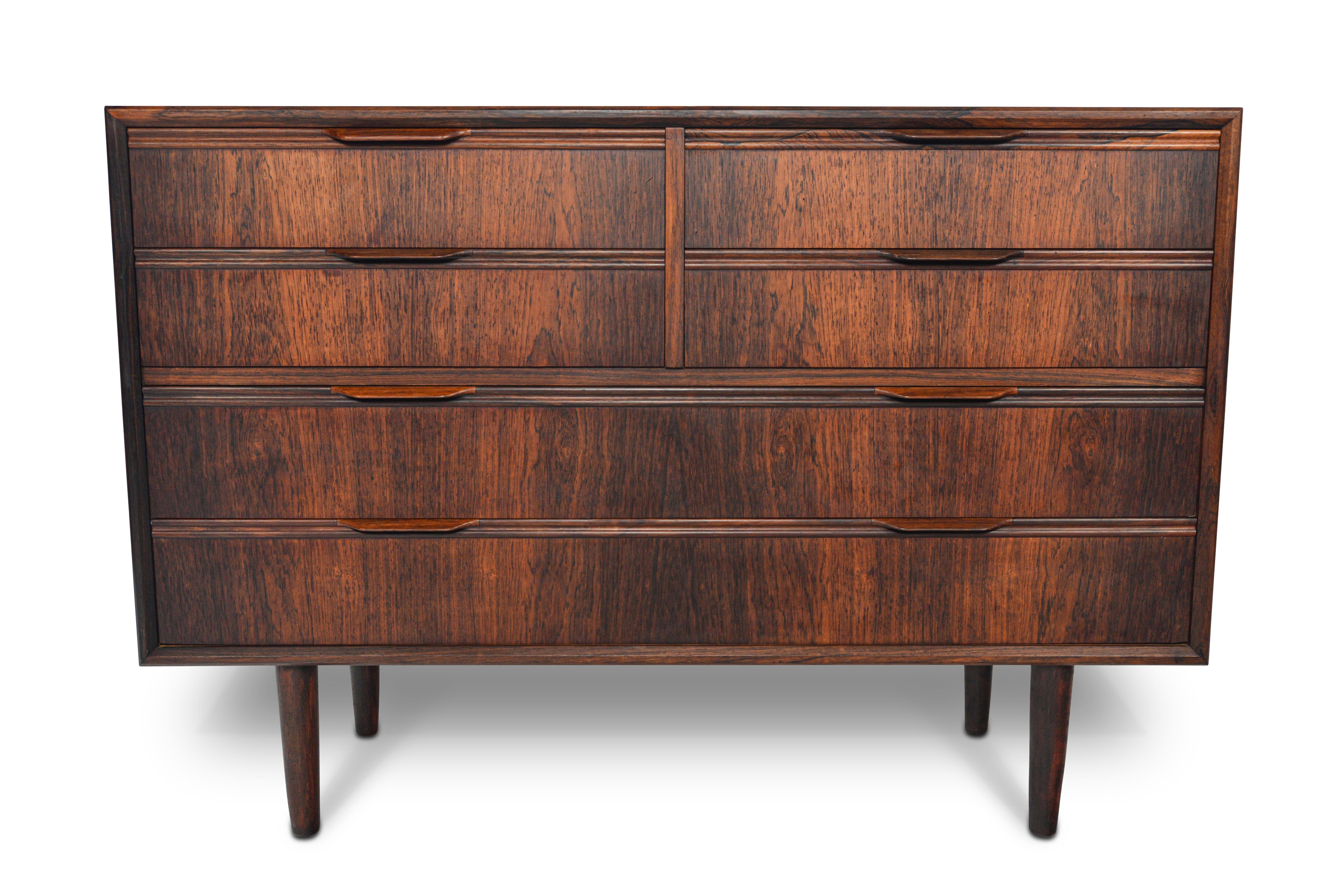 This rare Danish modern low six-drawer dresser by Knud Nielsen offers a wider, lower silhouette for bedroom storage. Crafted in rosewood, the top of this piece features four small drawers and two large lower drawers. In excellent original