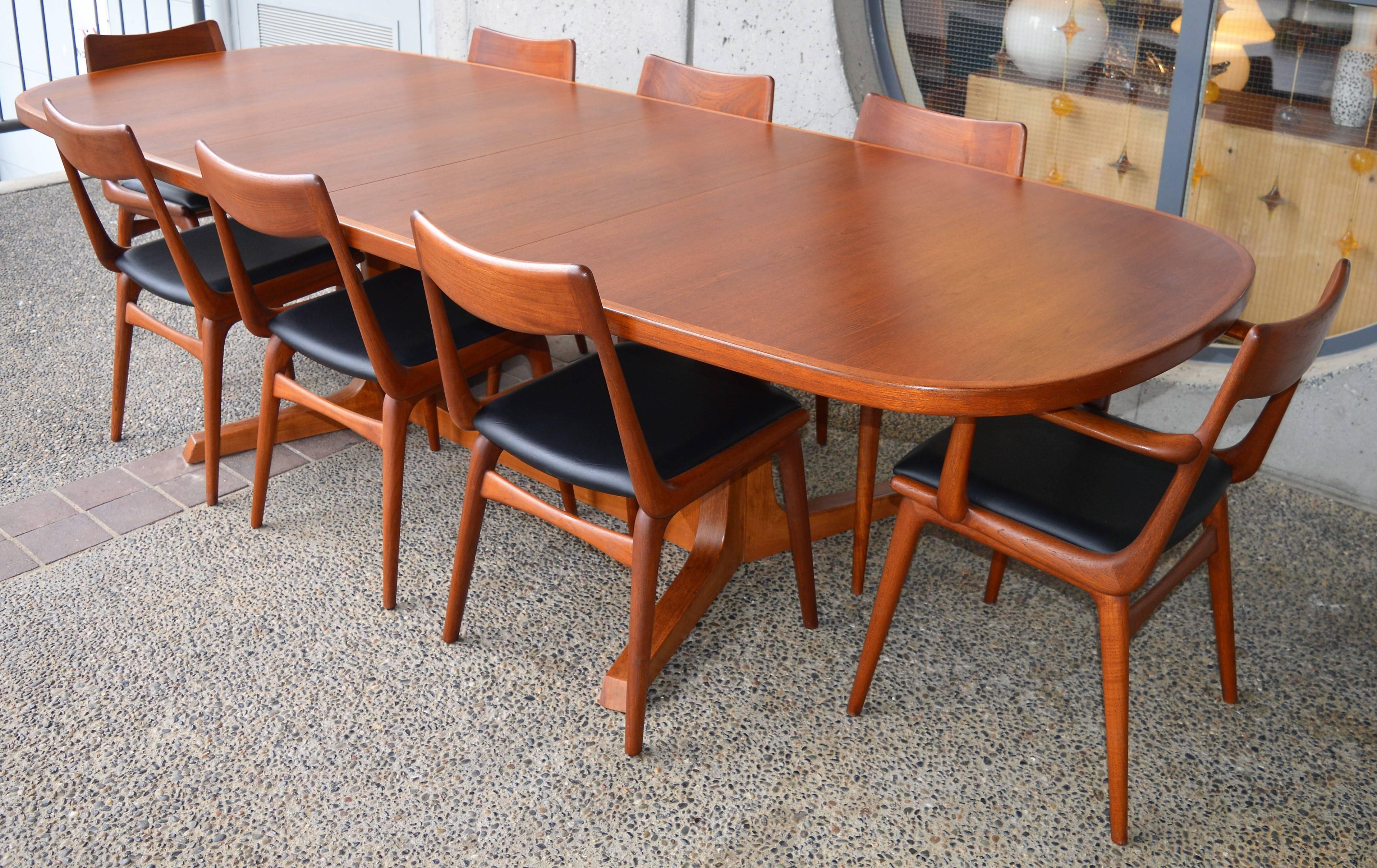 This stellar top quality teak dining table was designed by NO Moller for Gudme Mobelfabrik in the 1960s. The gorgeous crossed double pedestal base is a sculptural beauty, and the softly rounded oval table has fabulous proportions. This beauty
