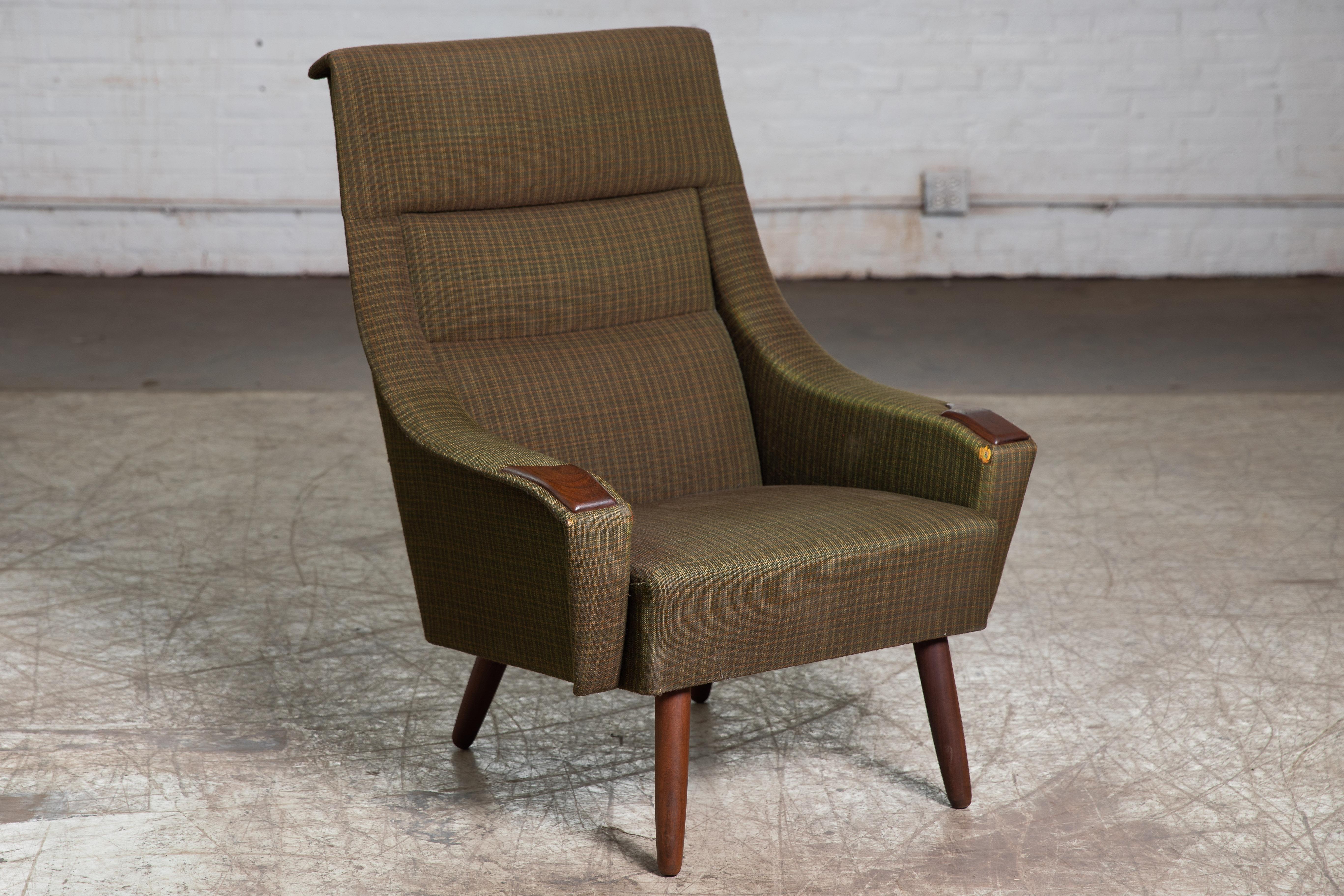 Beautiful Late 1950's or early 1960's classic danish modern lounge chairs boasting wood tipped arm rests, tapered teak legs, and a lovely olive green wool upholstery. The angled back rest and thick padded seating offer maximum comfort. A sleek and