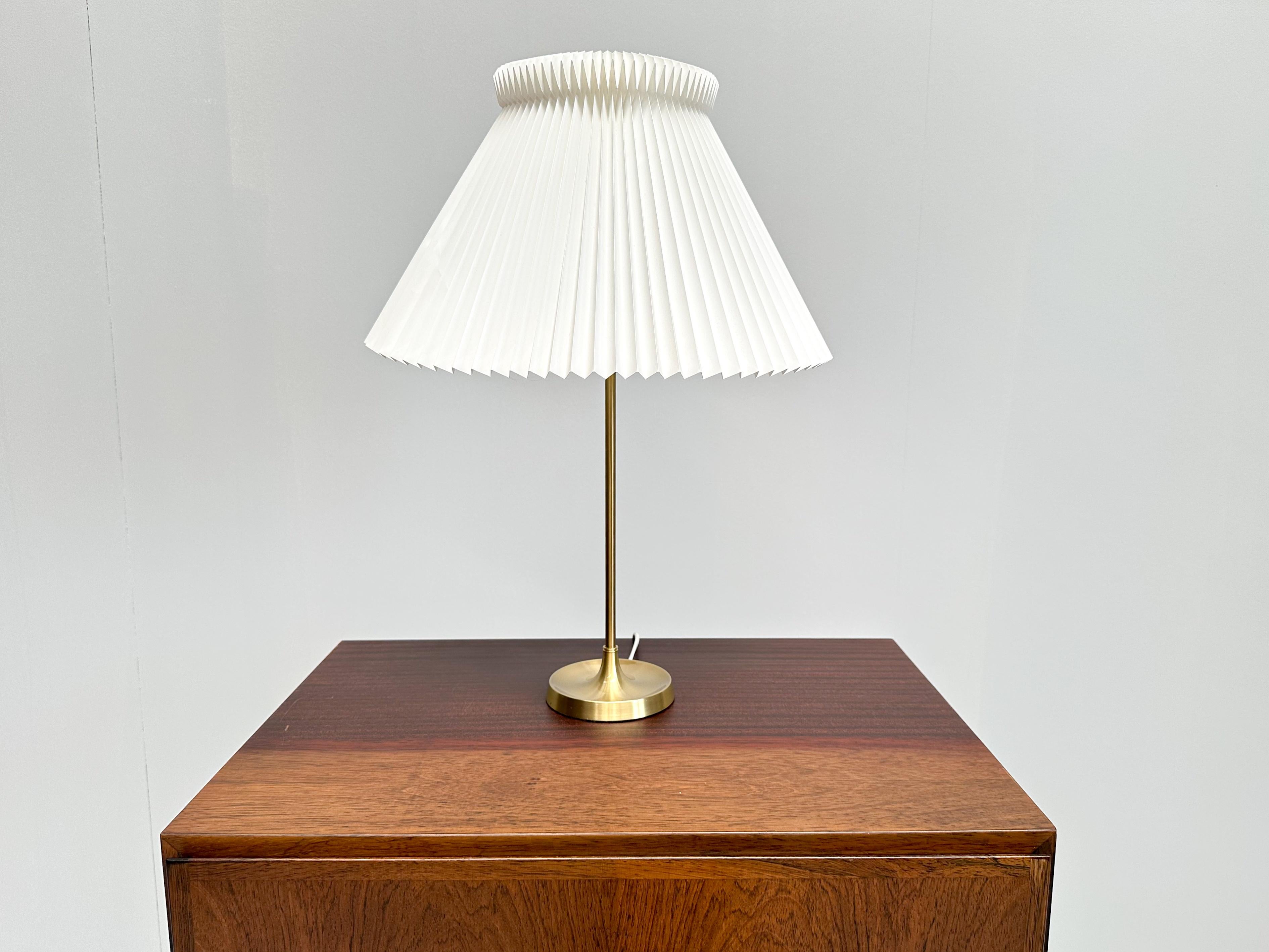 This elegant the Le Klint Model 307 lamp, originally designed by Esben Klint in 1948 has brass frame and pleated plastic shade.