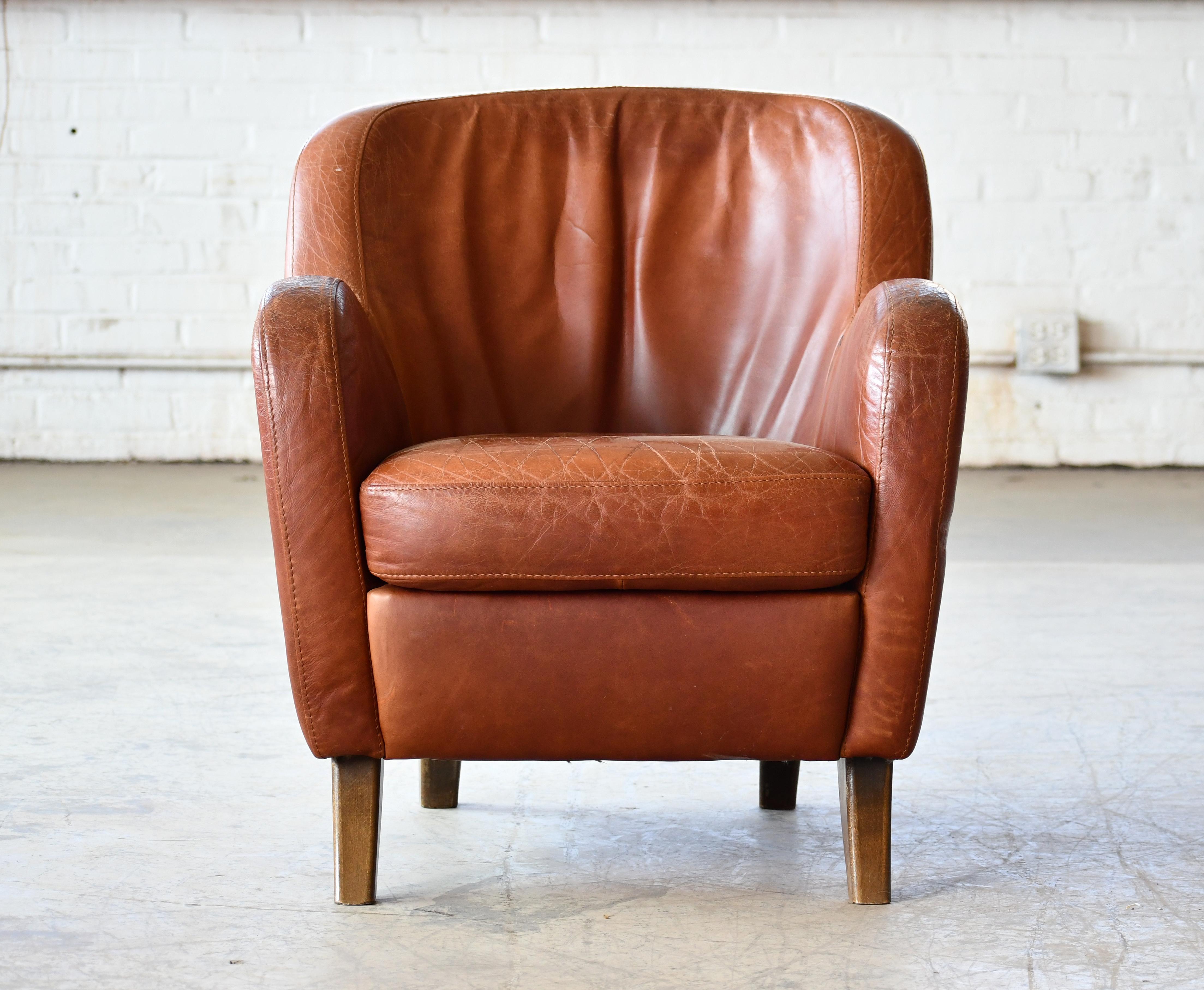 We found this bold and curvy armchair in Denmark but are not sure of the maker and Designer as the chair is unmarked.  The chair has a slight tilt backwards and a similar style and stance as the famous 1940's chair from Berga Mobler but it is of
