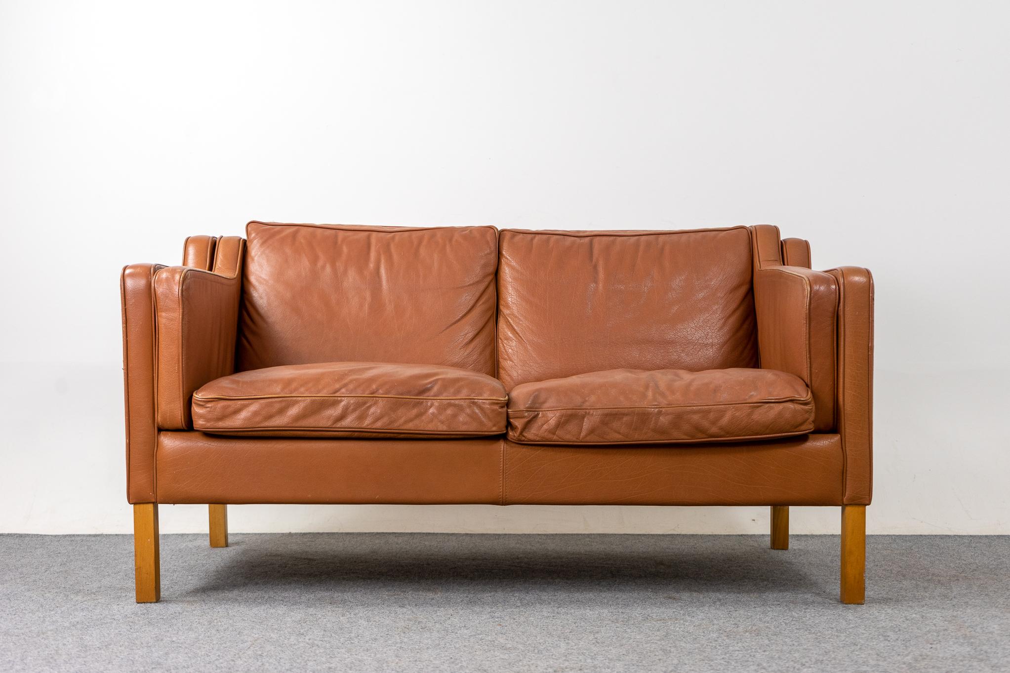 Leather loveseat by Stouby, circa 1960's. Tan soft and supple leather that is durable to ensure years of use and enjoyment. Compact footprint make this the perfect seating solution for urban dwellers in cozy lofts or condos. Great patina! 

Please