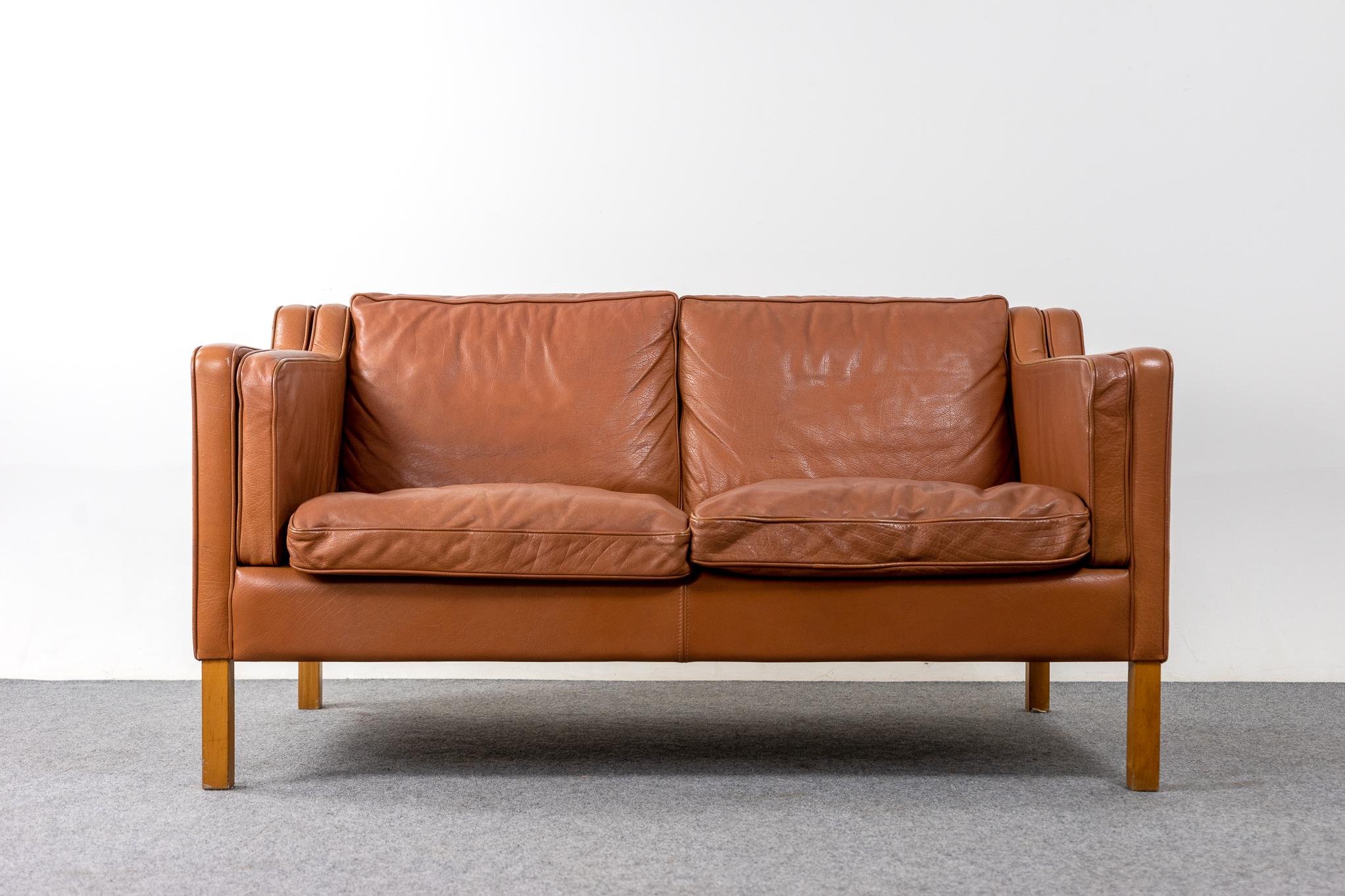 Leather loveseat by Stouby, circa 1960's. Tan soft and supple leather that is durable to ensure years of use and enjoyment. Compact footprint make this the perfect seating solution for urban dwellers in cozy lofts or condos. Great patina! 

Please