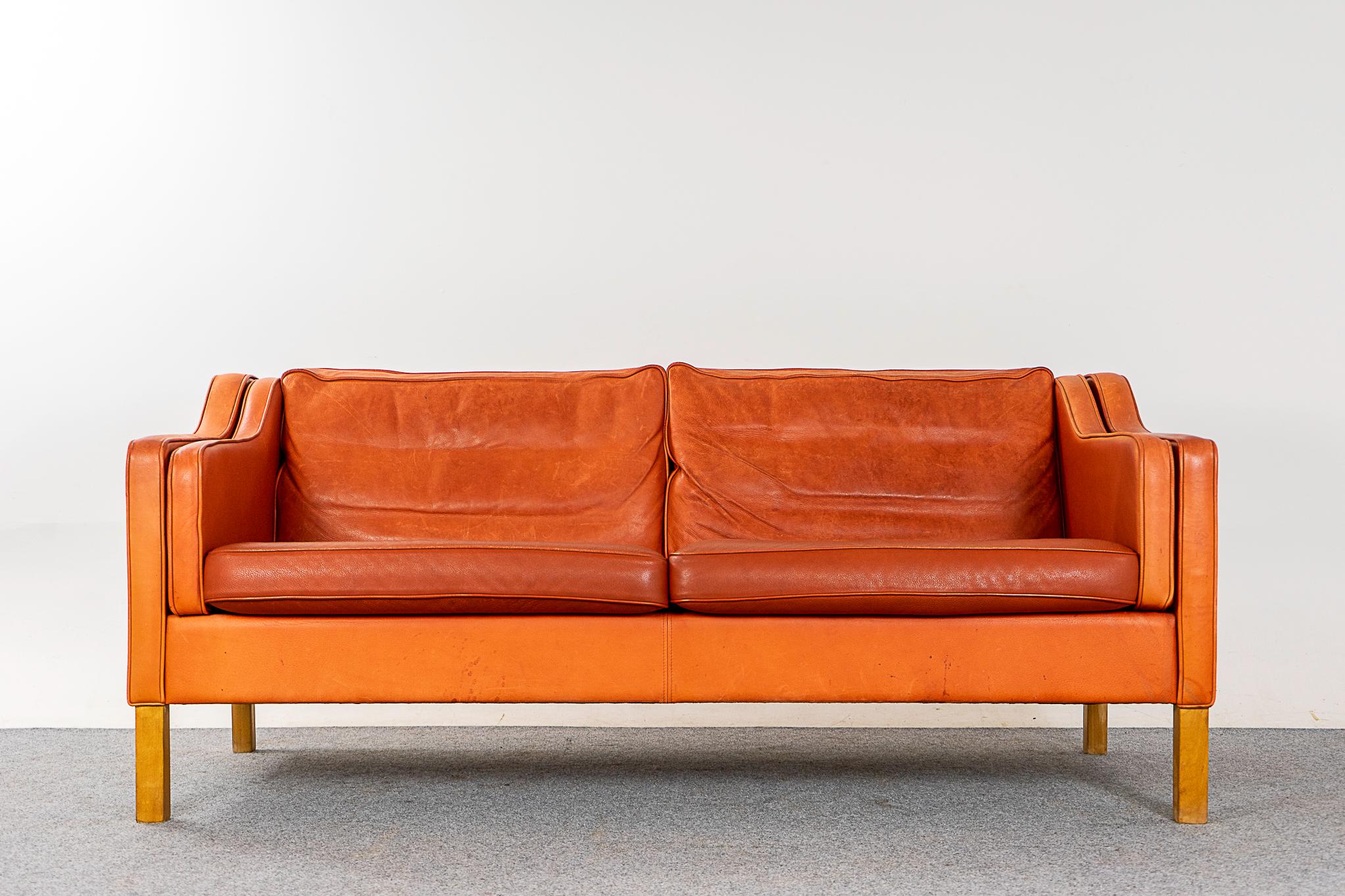 Leather Danish modern loveseat, circa 1960s. Soft and supple, yet durable enough to ensure years of enjoyment. Tangerine leather is highly patinated.

Please inquire for international shipping rates.