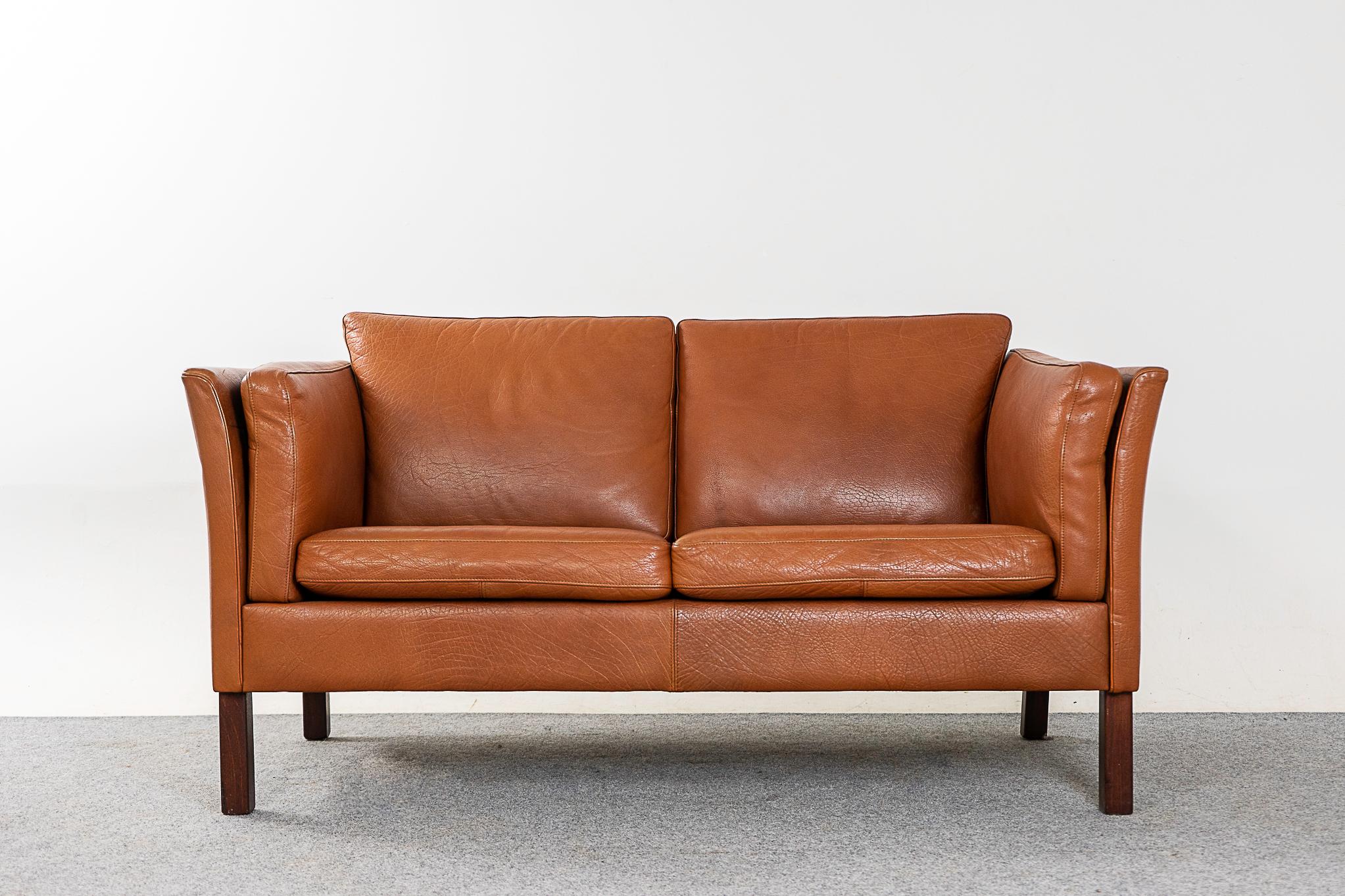 Leather Danish loveseat, circa 1960s. Soft, supple vintage butterscotch leather is still durable enough to ensure years of use and enjoyment. Compact footprint, a 
perfect seating solution for urban dwellers. 

Please inquire for international