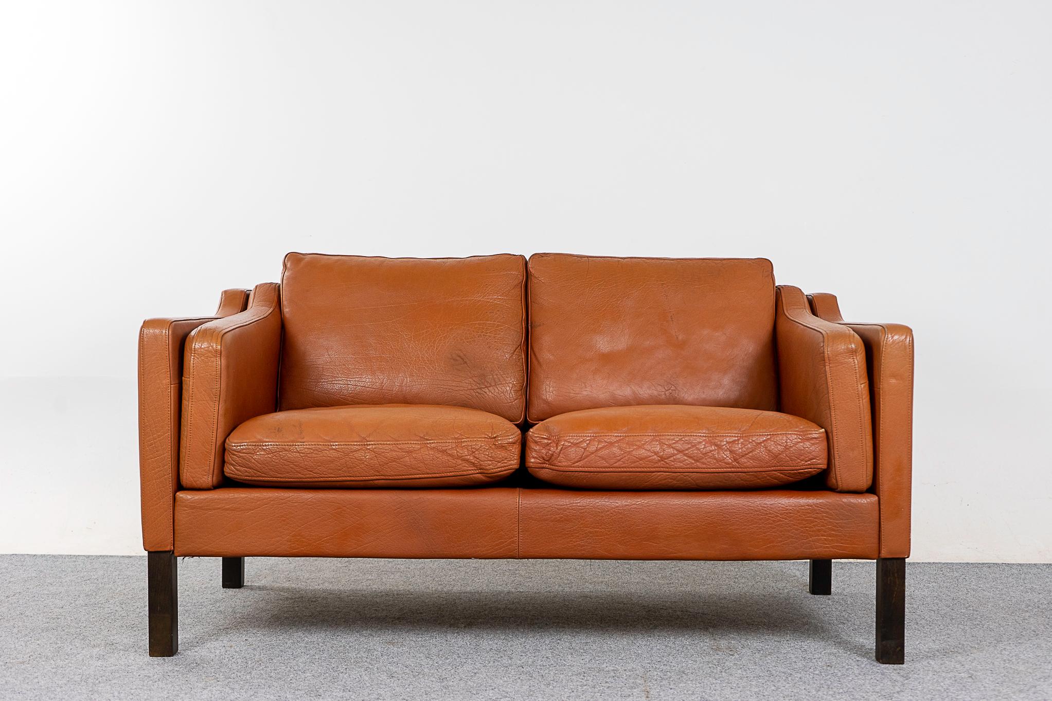 Leather loveseat, circa 1960's. Original tan leather is soft and supple while also being durable to ensure years of use and enjoyment.

Please inquire for remote and international shipping rates.