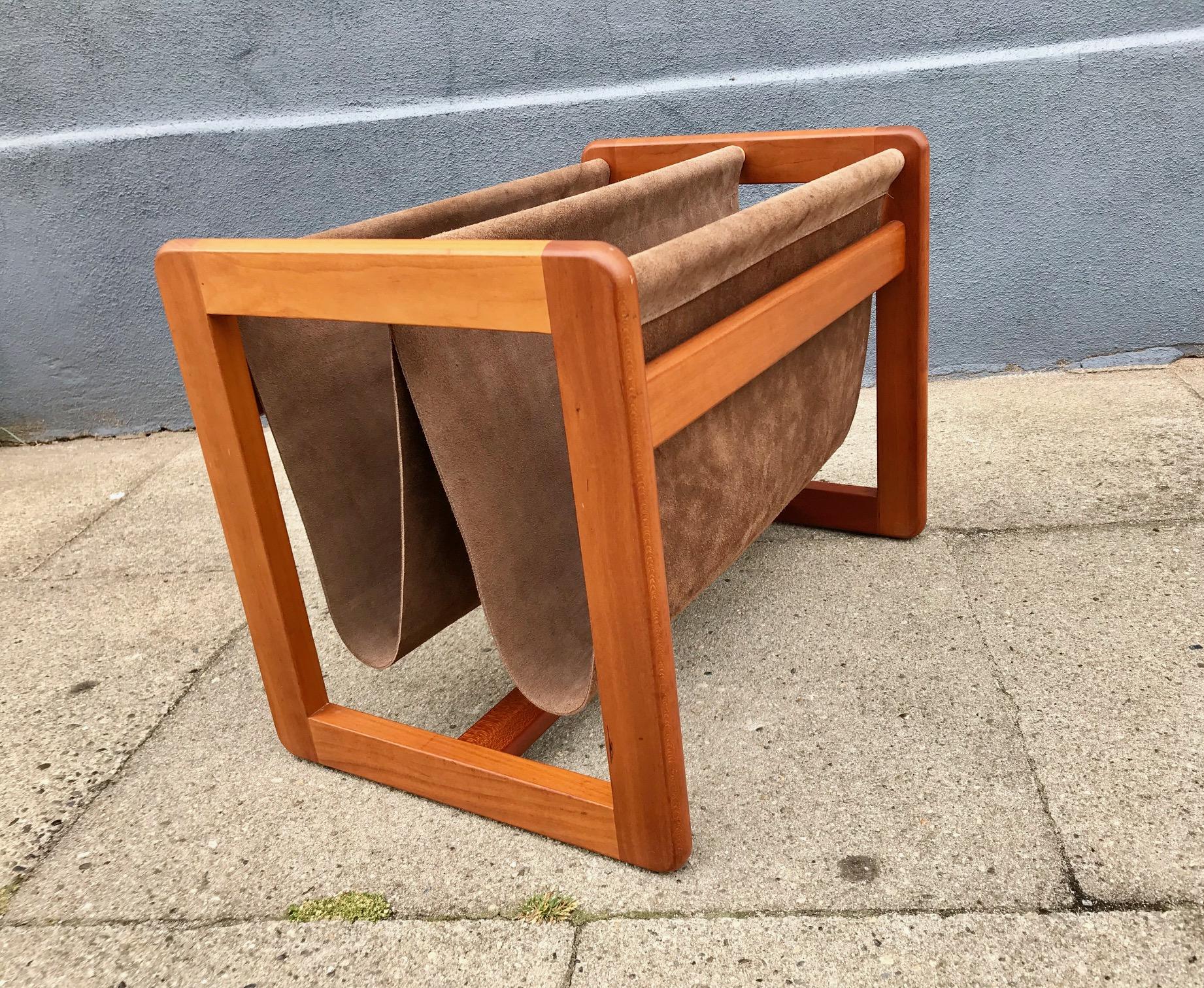 Magazine holder designed by Danish Aksel Kjersgaard
in the 1960s. Dual brown suede leather cradle slings. Solid teak frame. Branded 