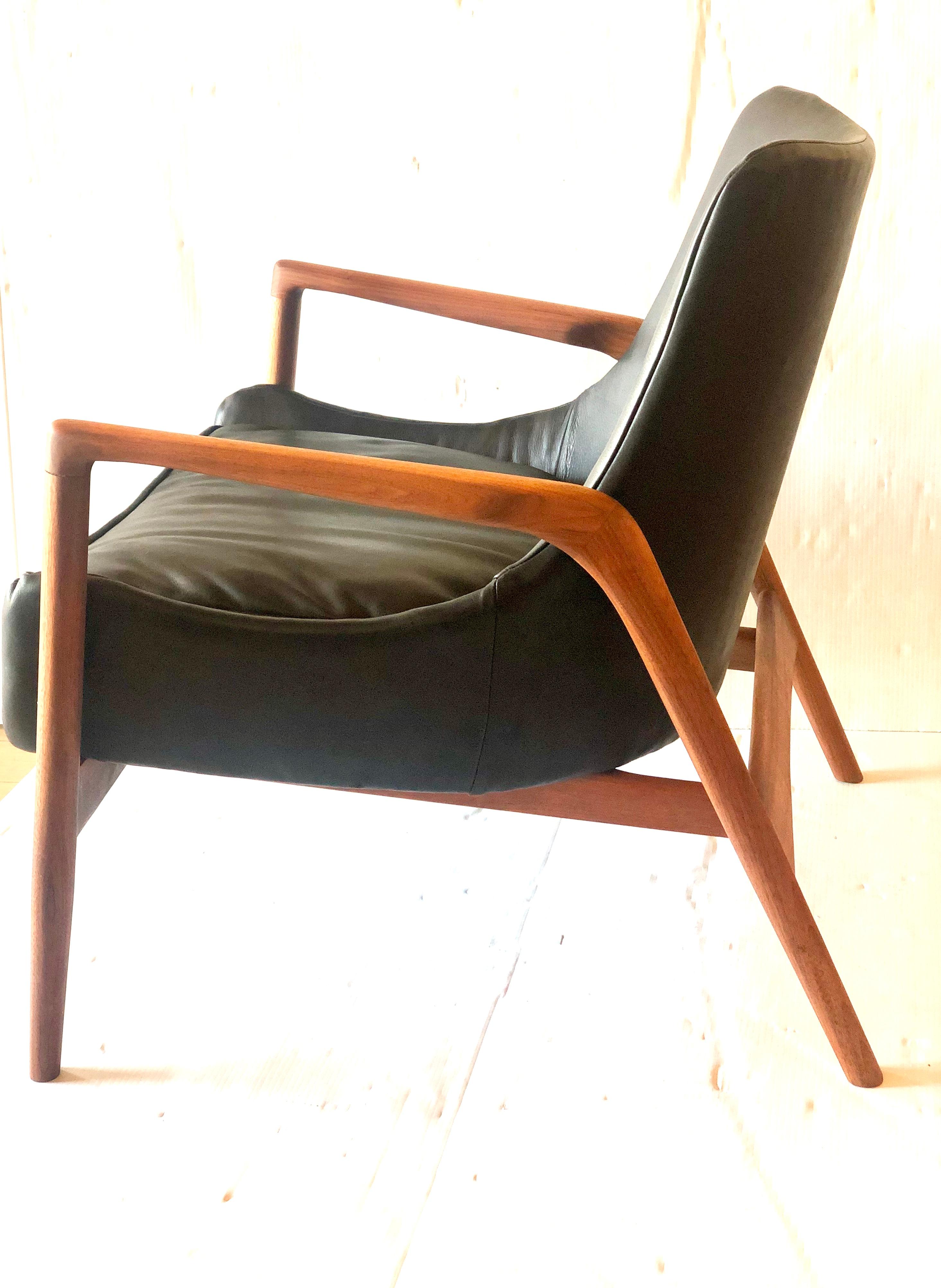 Nice lounge armchair designed by Kofod Larsen, circa 1950s new leather upholstery and freshly refinished walnut frame, solid and sturdy .