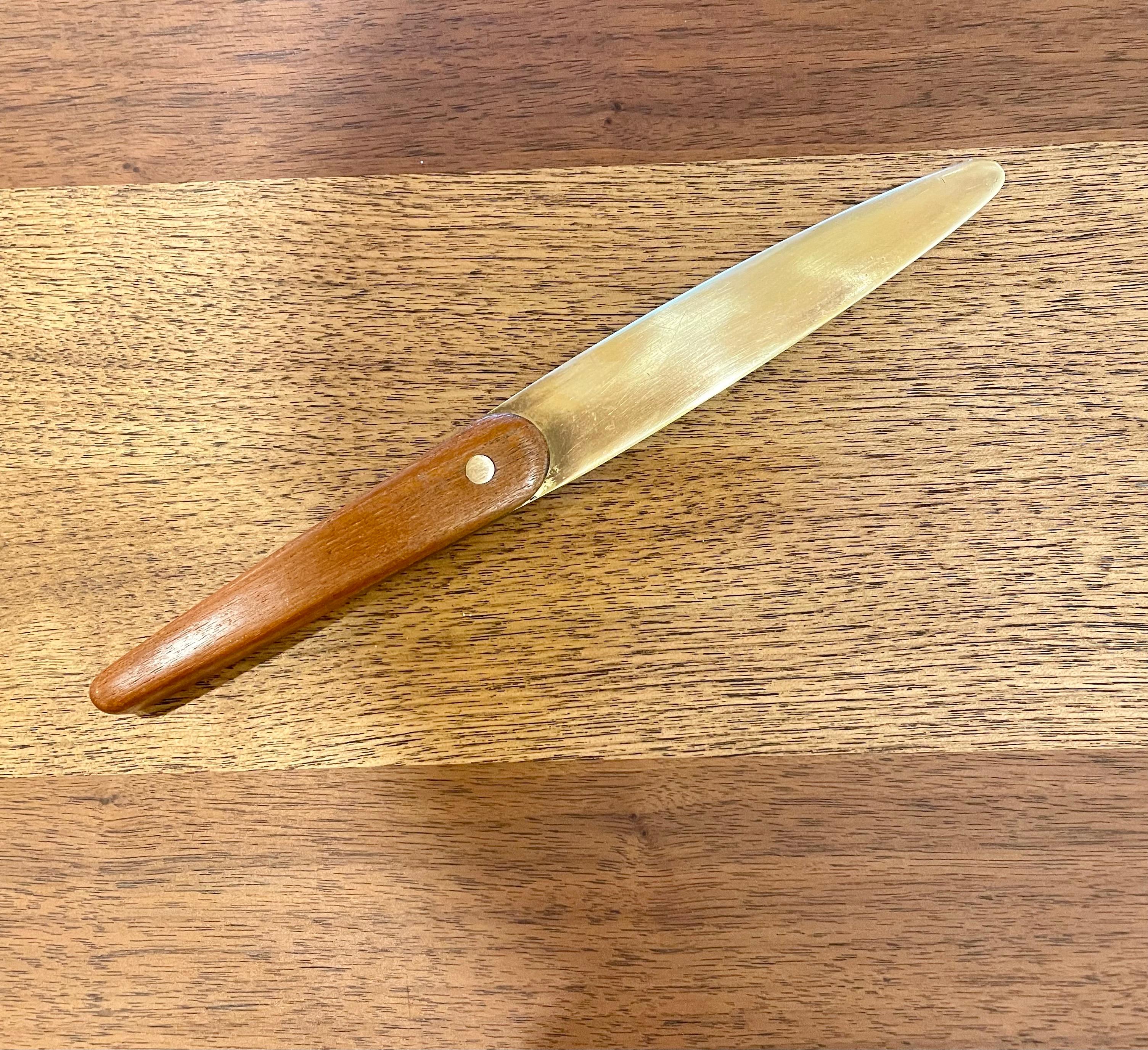 Letter opener in teak and brass, designed by Jens Quistgaard, and produced by Dansk. Measures: 10 1/4” long and 1