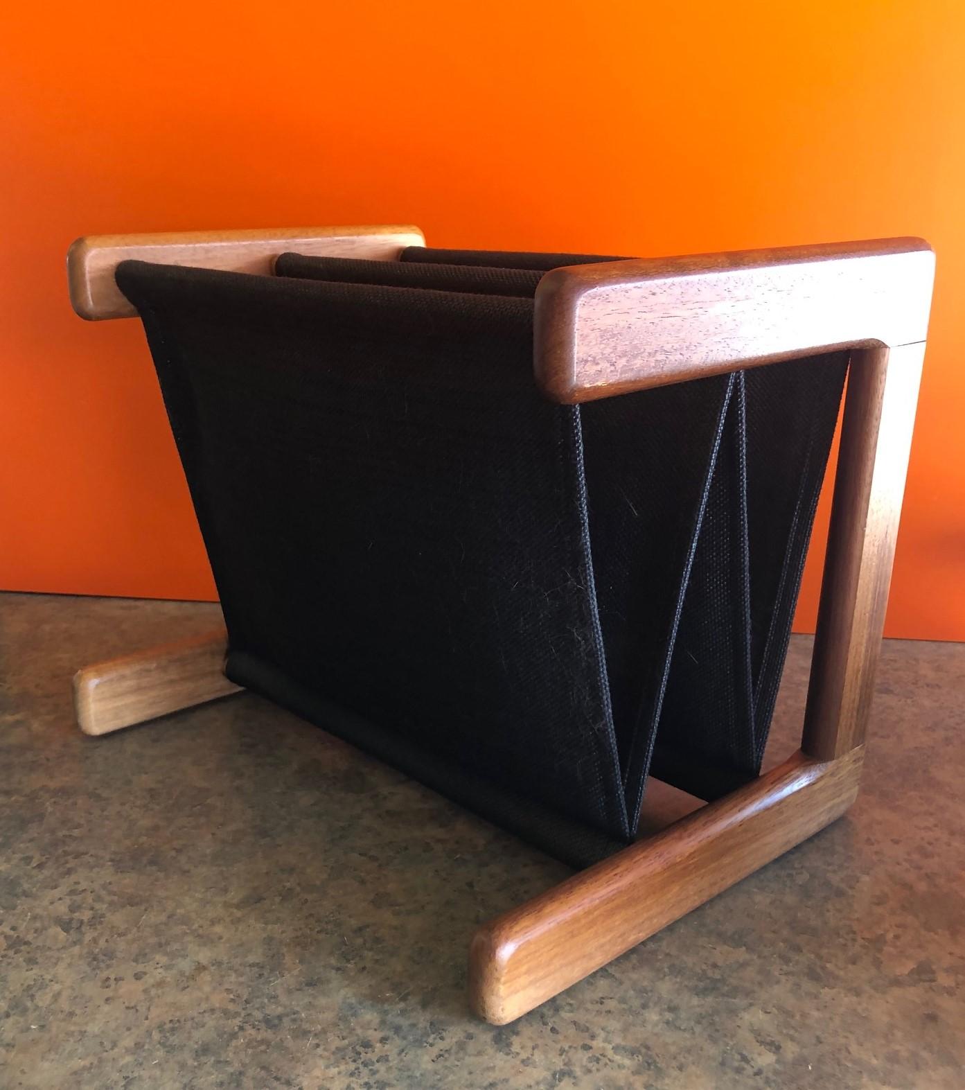 Danish modern linen and teak double magazine rack, circa 1970s. A solid teak frame and chocolate linen inserts make this a very attractive and functional magazine rack for any MCM room.