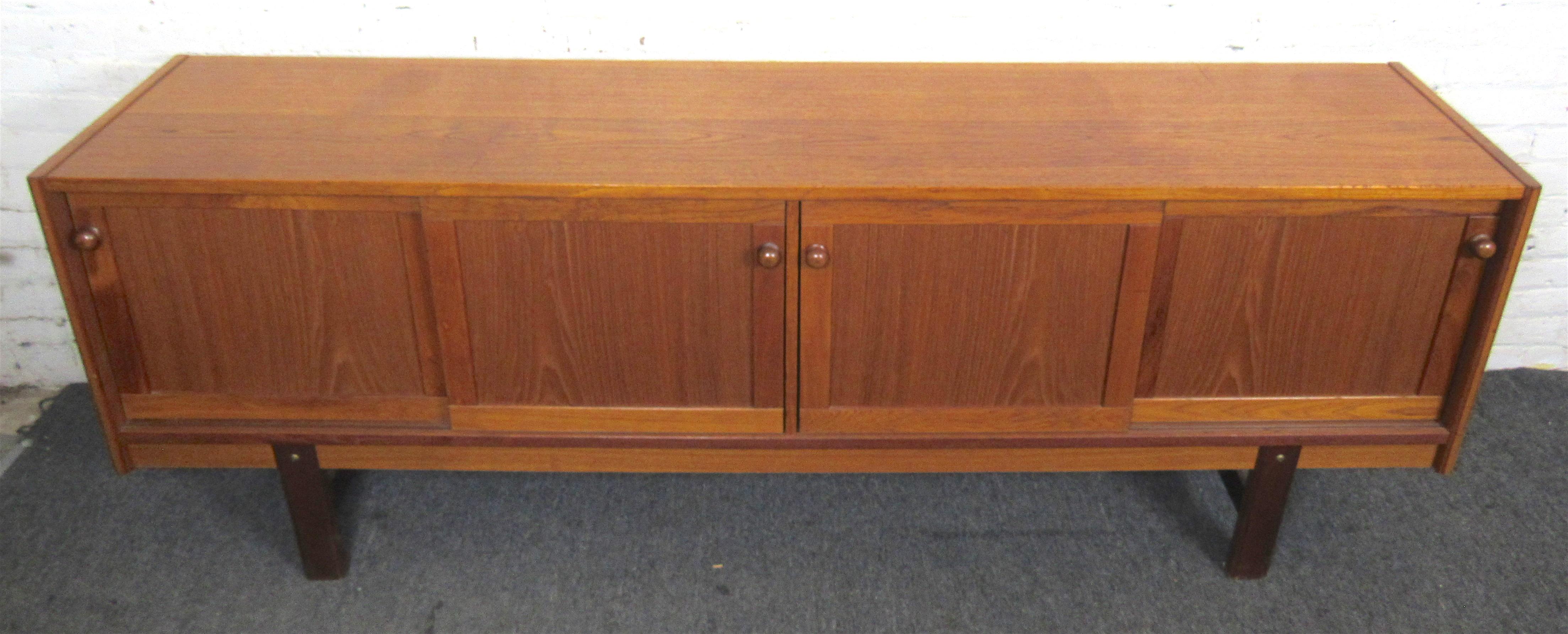 Sliding door cabinet with warm teak wood grain. Simple mid-century modern style and design for home or office use.
(Please confirm location NY or NJ).