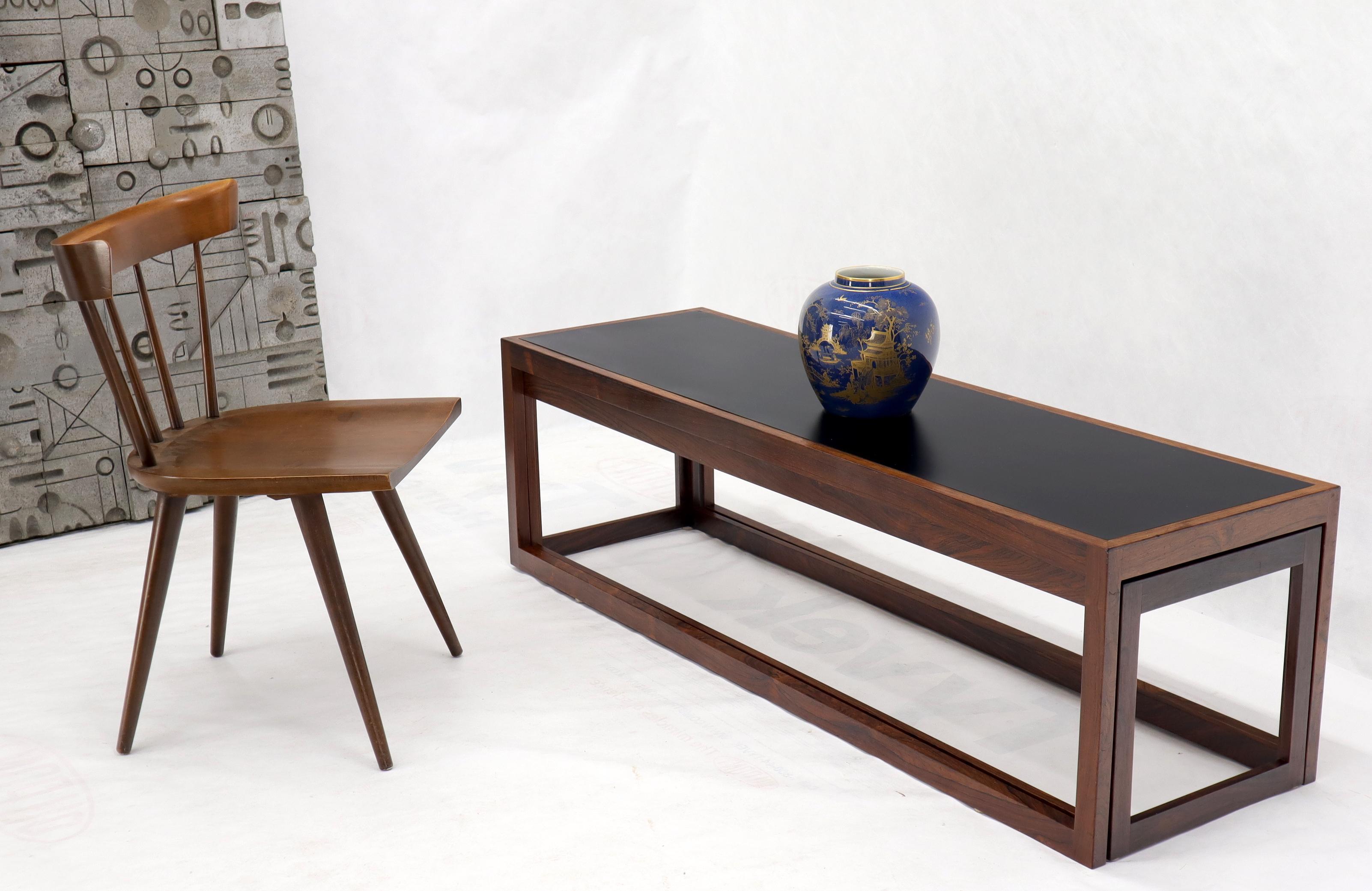 Danish Mid-Century Modern solid rosewood frames black laminated top nesting coffee tables.