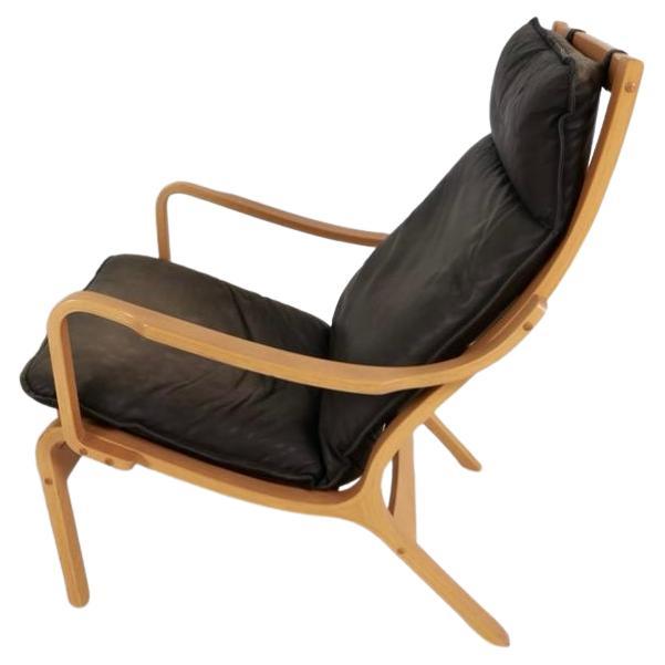 Danish Modern lounge chair and ottoman in bent beech wood and brown leather. This chair has Skippers label under the cushion. Designed by Finn Ostergaard for Skippers mobler. Denmark Circa 1980's.

Sold as a combo chair and ottoman 

Chair H 39