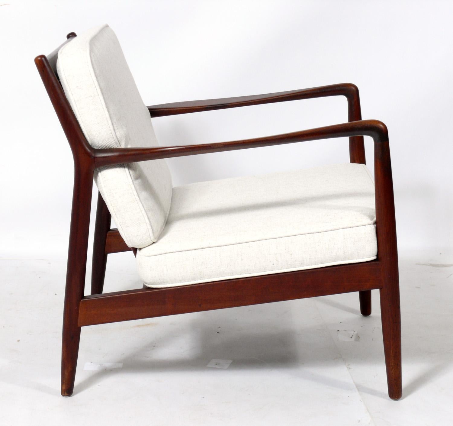 Danish modern lounge chair, designed by Folke Ohlsson for DUX, Denmark, circa 1960s. It has been reupholstered in an ivory color herringbone upholstery. The teak frame has been cleaned and Danish oiled.