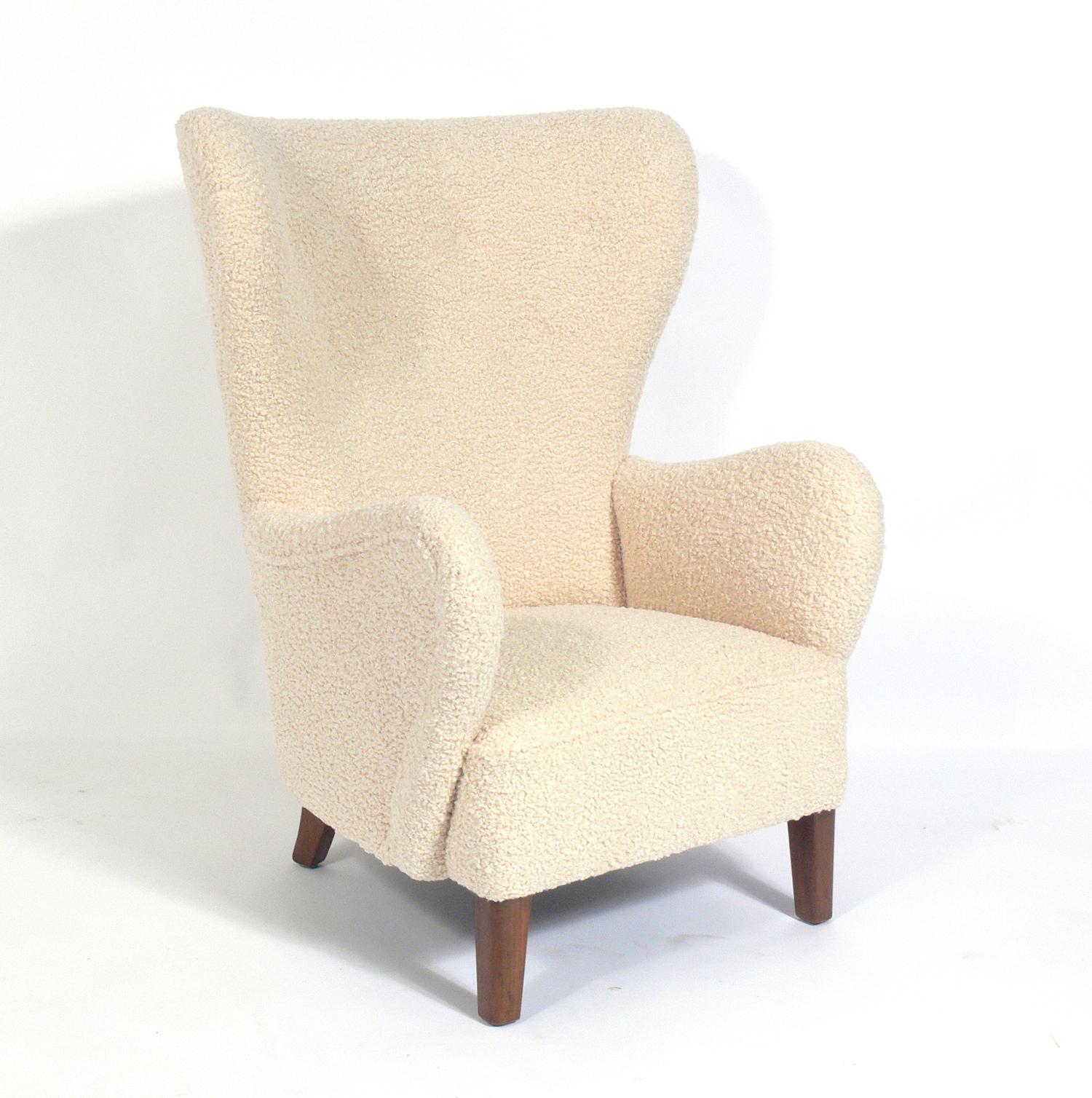 Danish modern lounge chair, designed by Fritz Hansen, Denmark, circa 1940s. It has been reupholstered in a plush faux shearling fabric. The wood legs, believed to be beech, have been cleaned and Danish oiled.