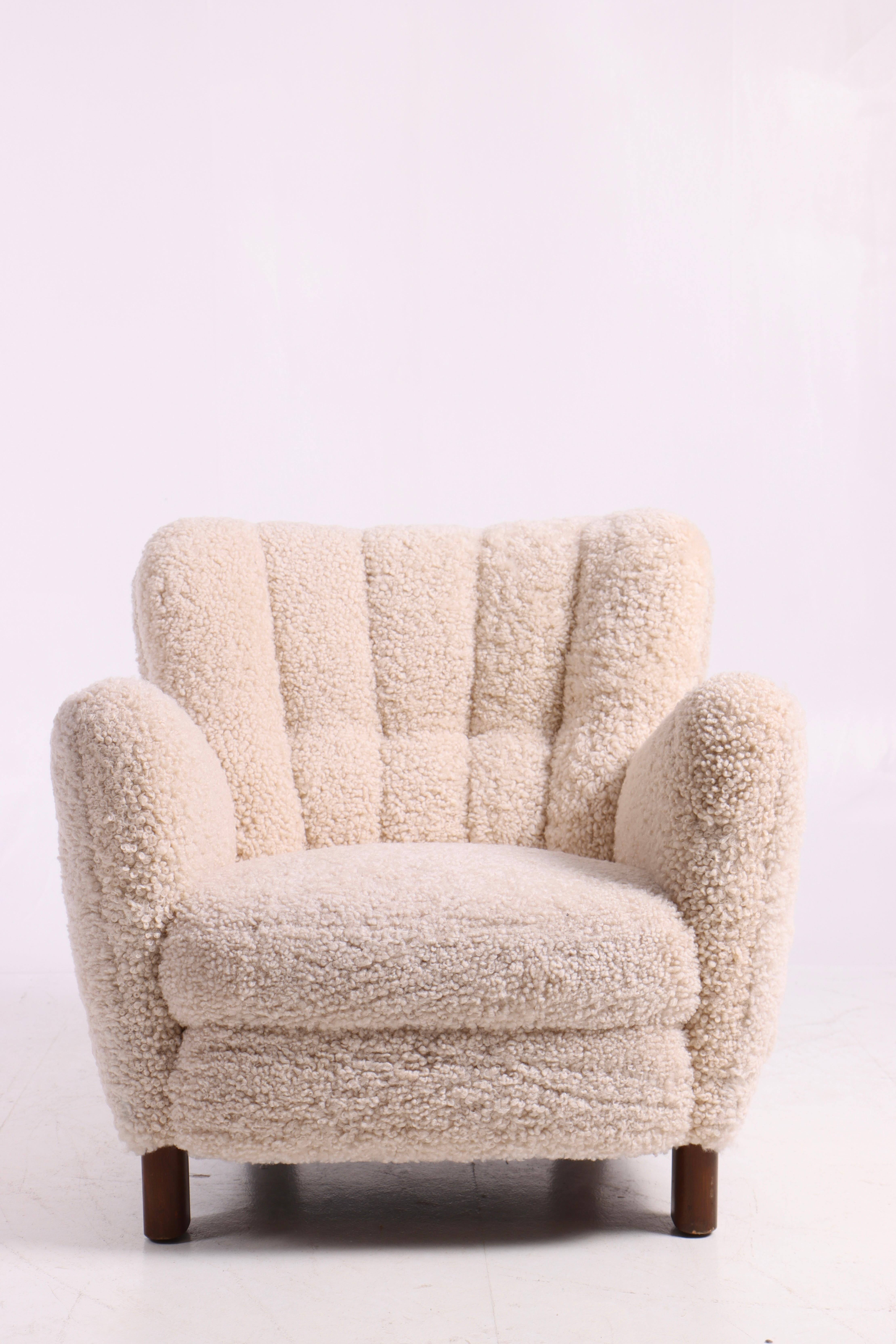 Lounge chair in upholstered in sheepskin. Designed and made by Fritz Hansen cabinetmakers in 1940s. Great condition.