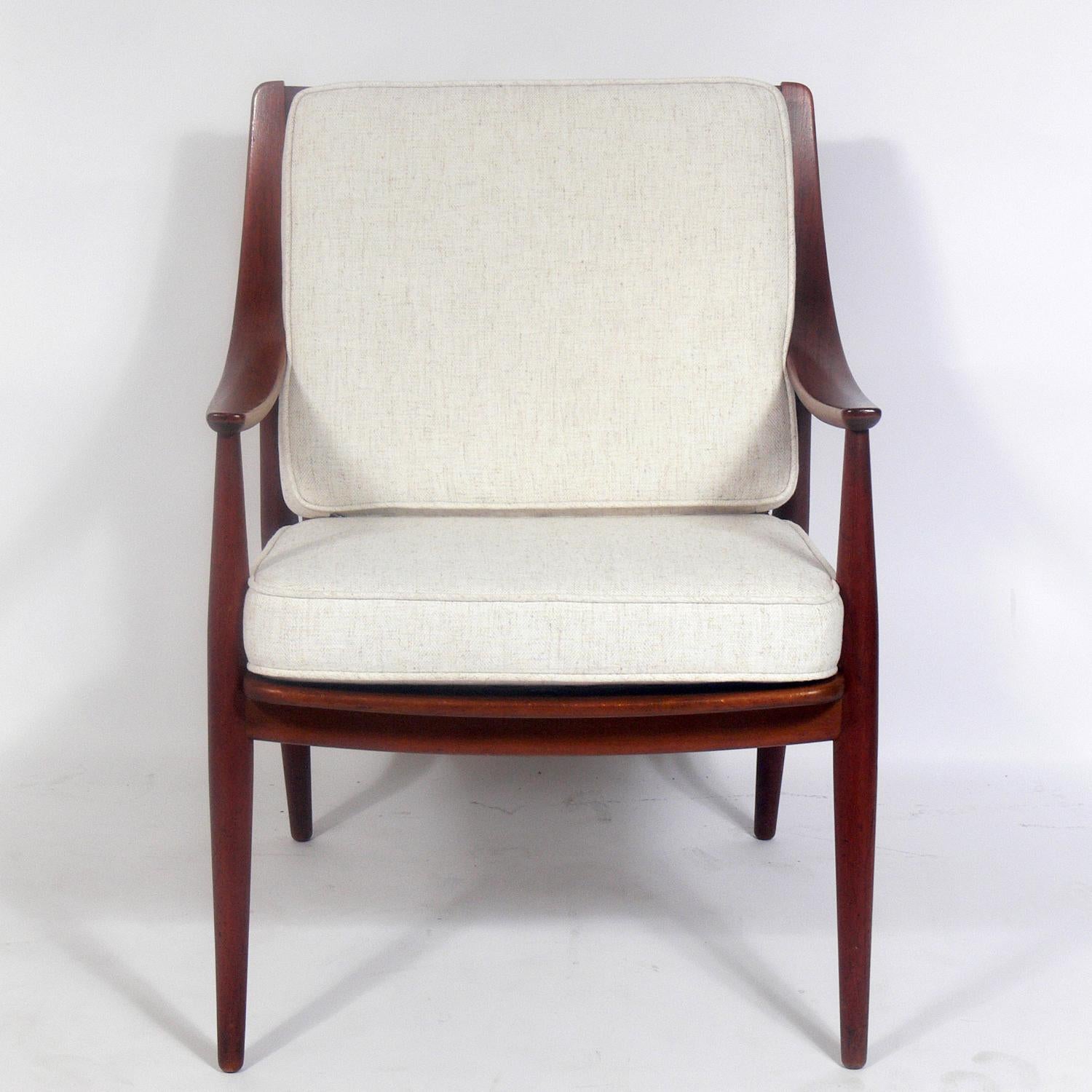 Danish modern lounge chair, designed by Peter Hvidt & Orla Mølgaard Nielsen for France & Daverkosen and retailed by John Stuart of NYC, circa 1960s. It has been reupholstered in an ivory color herringbone fabric. It retains it's original finish and