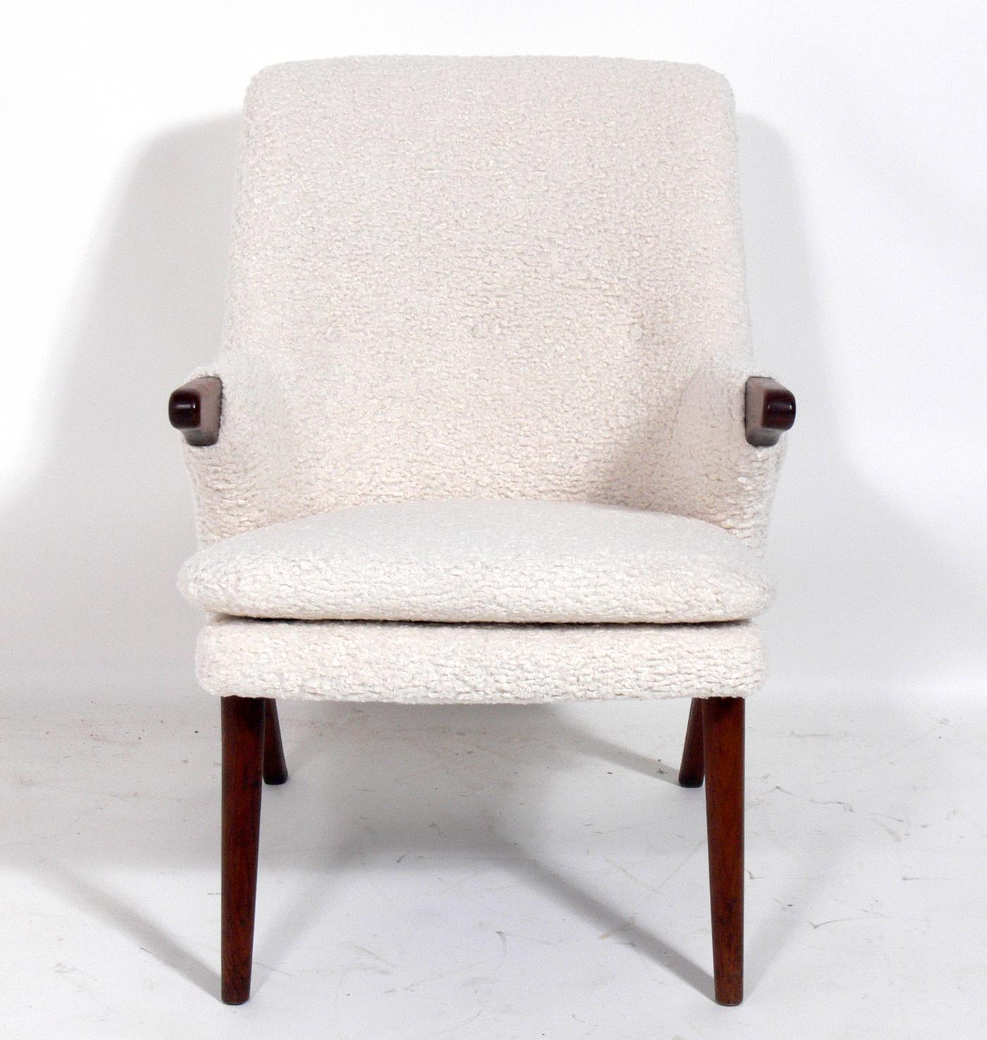 Danish modern lounge chair, in the manner of Hans Wegner, Denmark, circa 1960s. Very sculptural form reminiscent of Wegner's Papa Bear chair. This chair has been recently reupholstered in a plush faux sheepskin. Teak arms and legs have been cleaned