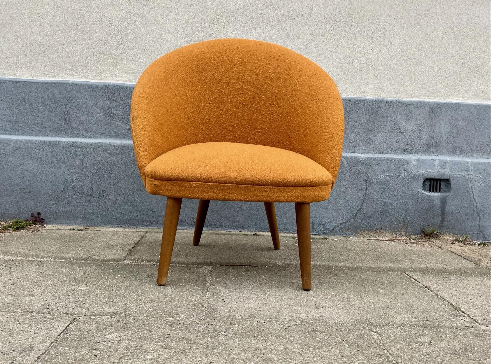Low-riding danish lounge chair commonly referred to as a pot chair. This one features its original 1960s wool upholstery and tapered solid teak legs. It was probably made by either Skippers Møbler or N. A. Jørgensen in Denmark during the late 1950s