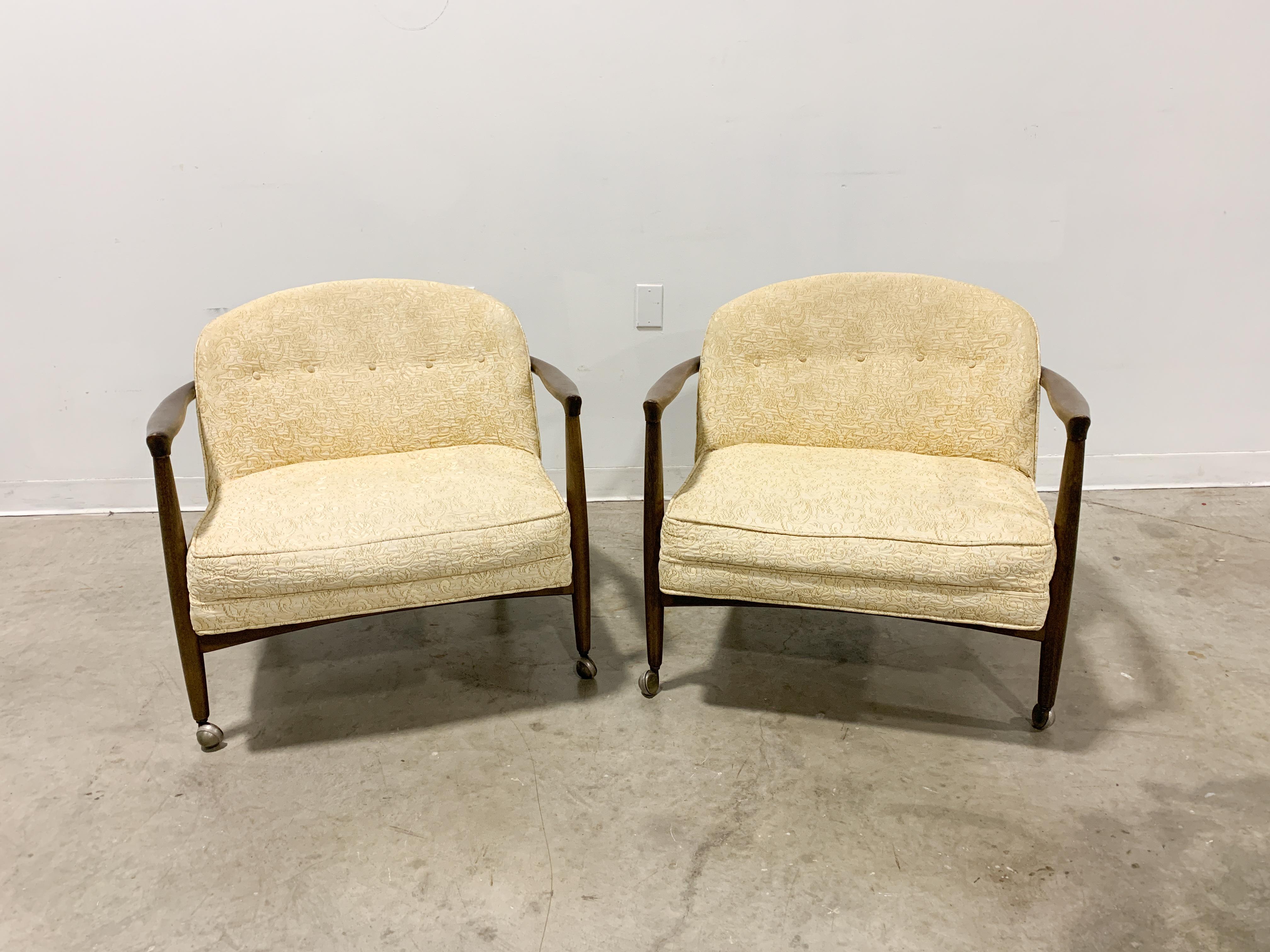 Very comfortable barrel back lounge chairs designed by Finn Andersen and distributed by Selig. Solid beech frames with a tinted lacquer finish cradle a seat of original foam and upholstery. Chairs are in very good original condition with occasional