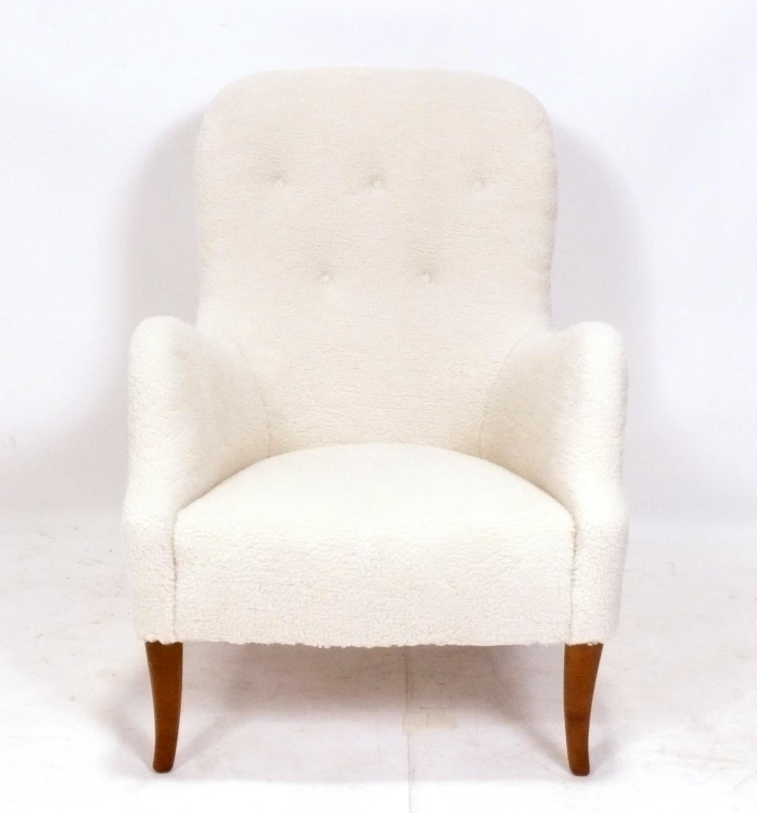 Sculptural Danish modern lounge chair upholstered in faux sheepskin fabric, attributed to Kerstin Horlin-Holmquist, Denmark, circa 1950s. It has been completely restored, with the legs refinished, and the body reupholstered in a plush faux sheepskin