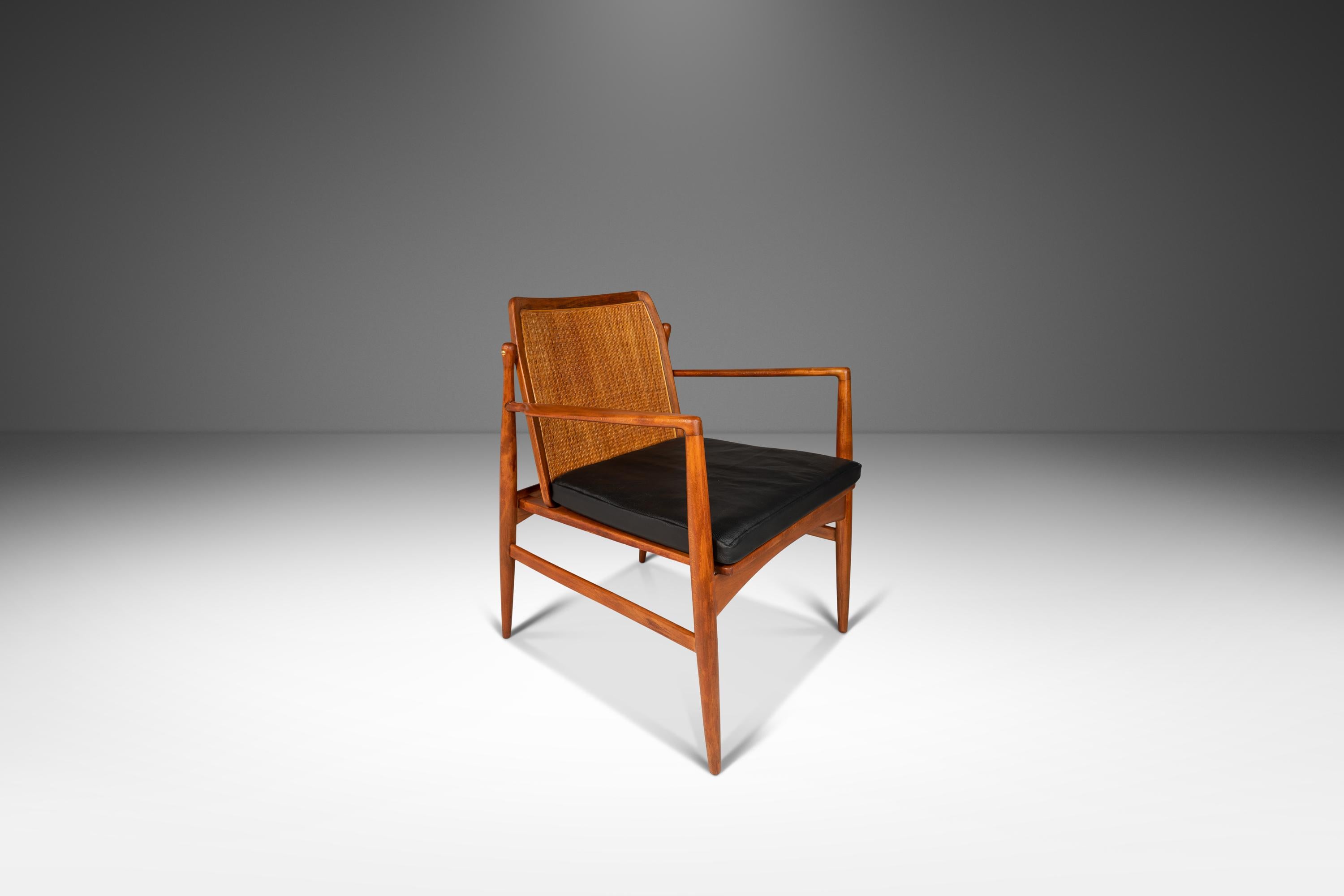 Introducing a true Danish Modern masterpiece: a rare cane back lounge chair designed by the incomparable Ib Kofod Larsen for Selig. This iconic armchair has been fully restored and newly upholstered, making it the perfect addition to any modern