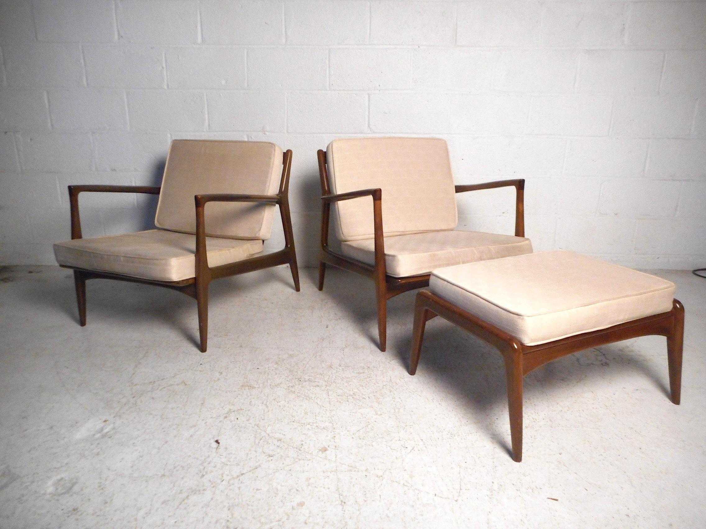 This stylish Danish modern set features a sleek angular design, sculpted armrests, and tapered legs. Deep seats and angled backrests provide style and comfort. Sure to make an impressive addition to any modern interior, circa 1950s, made in Denmark.