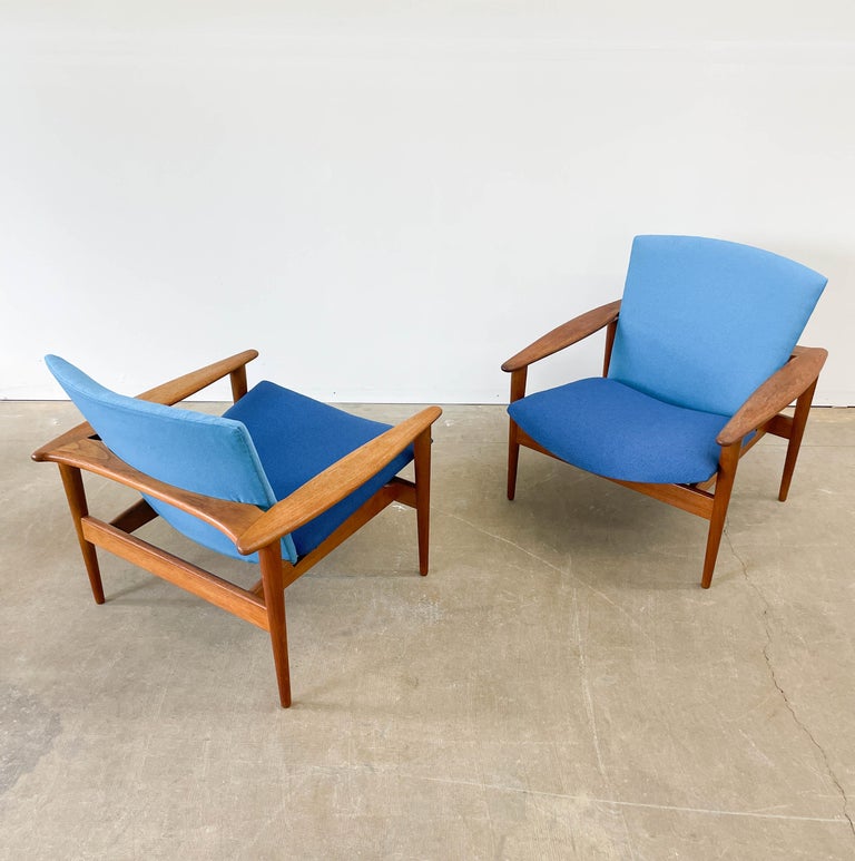 Beautiful solid teak lounge chairs from the late 1950s in new two-tone Maharam upholstery. While the designer of these fantastic chairs remains unknown amongst Danish modern collectors, we believe these chairs were designed by Illum Wikelso. With