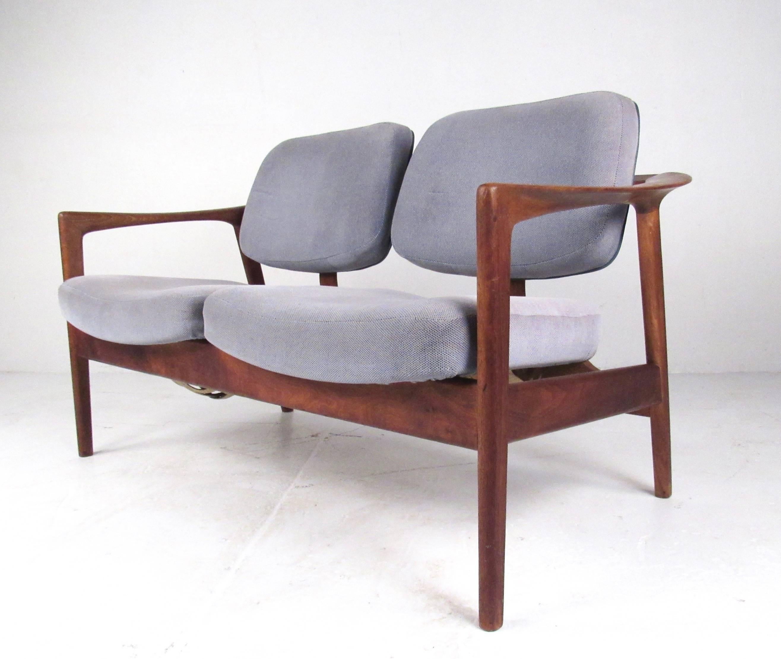 Distinctive Scandinavian Modern design sets this vintage DUX love seat apart from other seating options. The midcentury Swedish design features stylish two-seat arrangement, solid teak frame, and quality vintage upholstery. An ideal addition to home