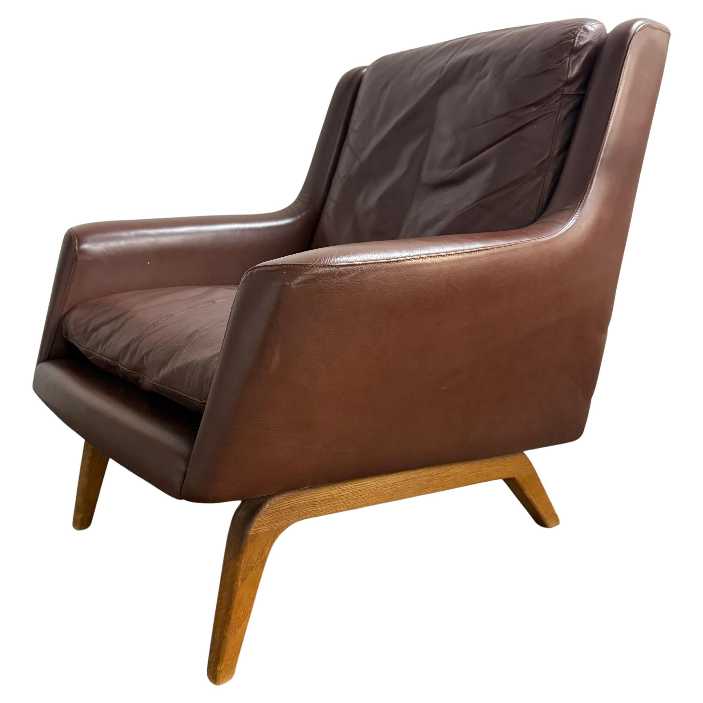 Danish Modern low brown Leather Lounge Chair with curved oak base