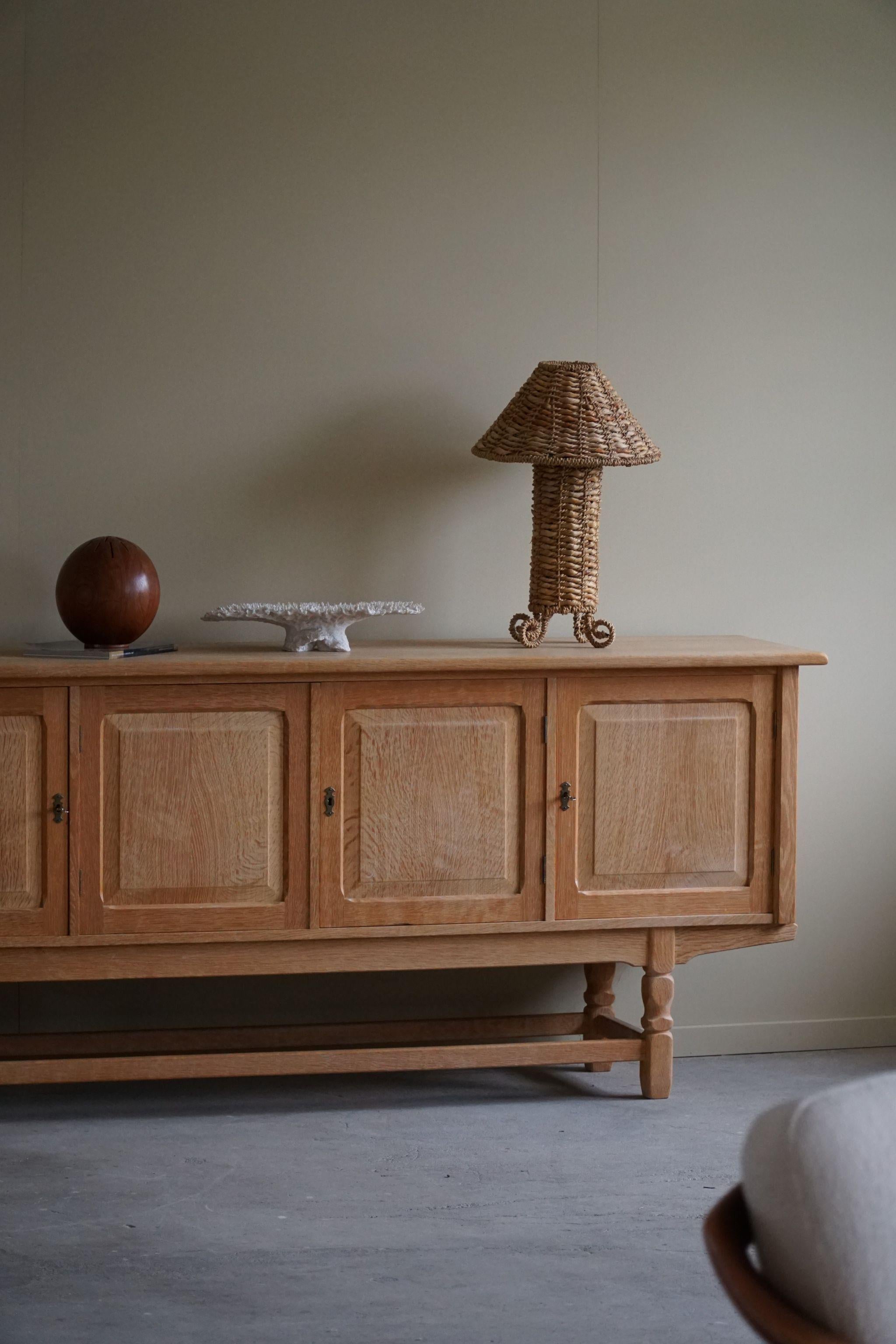 Beautiful low Classic sideboard in oak. Made by a Danish cabinetmaker in 1960s. This piece is in a great vintage condition, with few signs of wear.

This brutalist object will fit into many interior styles. A modern, Scandinavian, Classic or an Art
