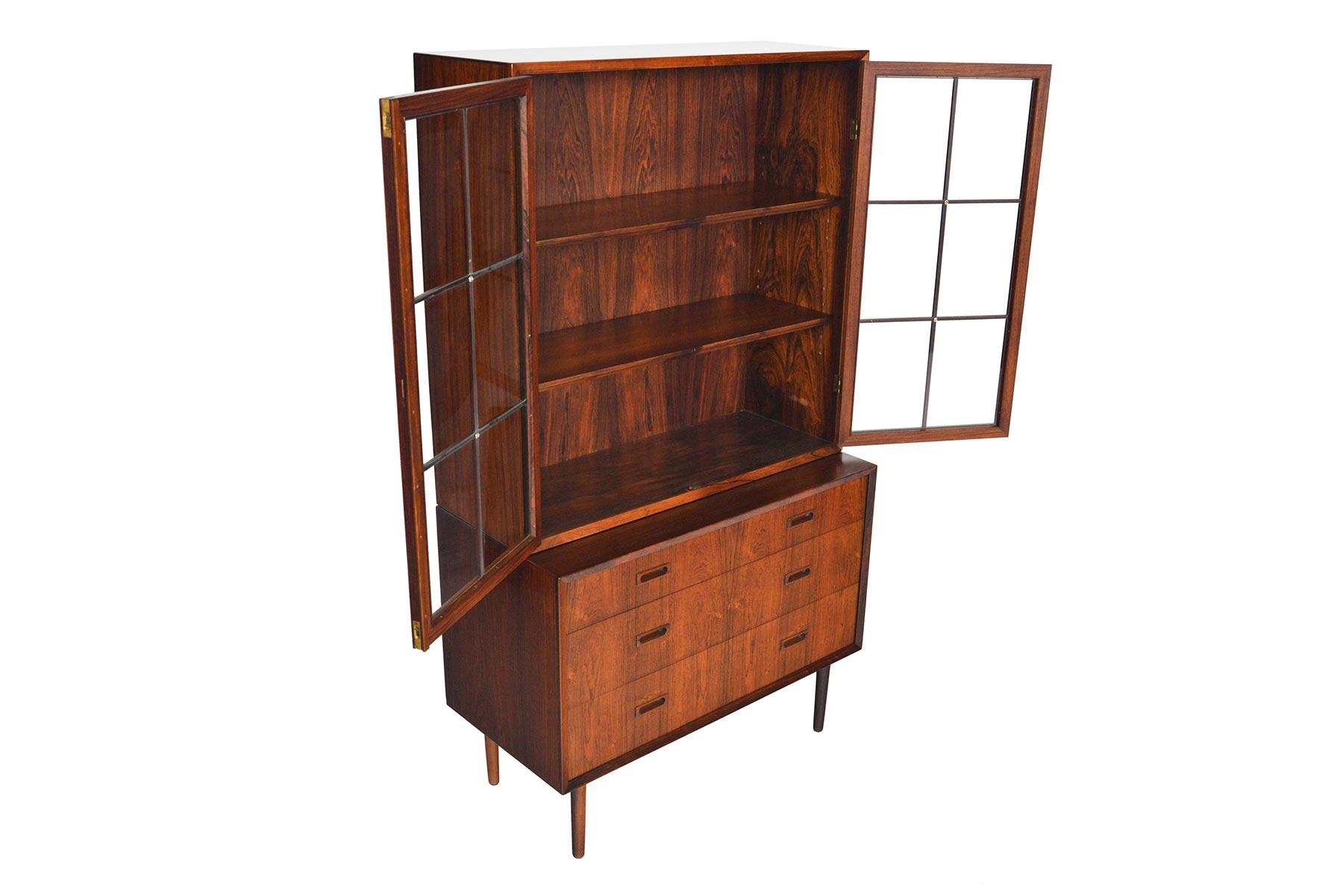 This versatile storage piece was manufactured by Lyby in the 1960s. Beautifully crafted the base of this piece is a four-drawer gentleman’s chest. A removable hutch with glass panels sits atop. Locking doors open to reveal two bays with adjustable