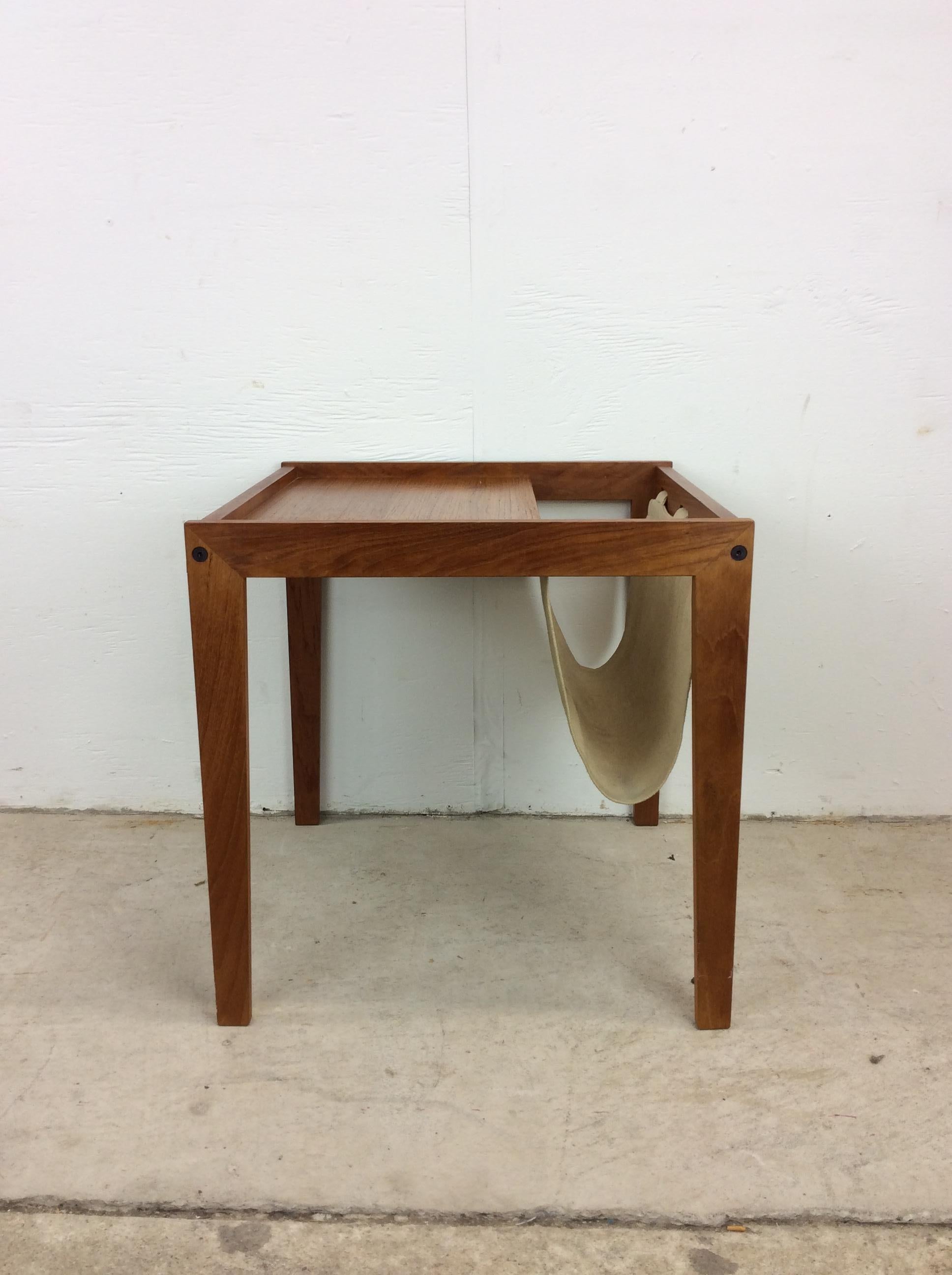 This Danish Modern table features solid teak construction with canvas sling magazine holder and tall tapered legs.

Please check out our other Danish Modern teak listings!

Dimensions: 18w 18d 18h

Condition: Original finish is in excellent