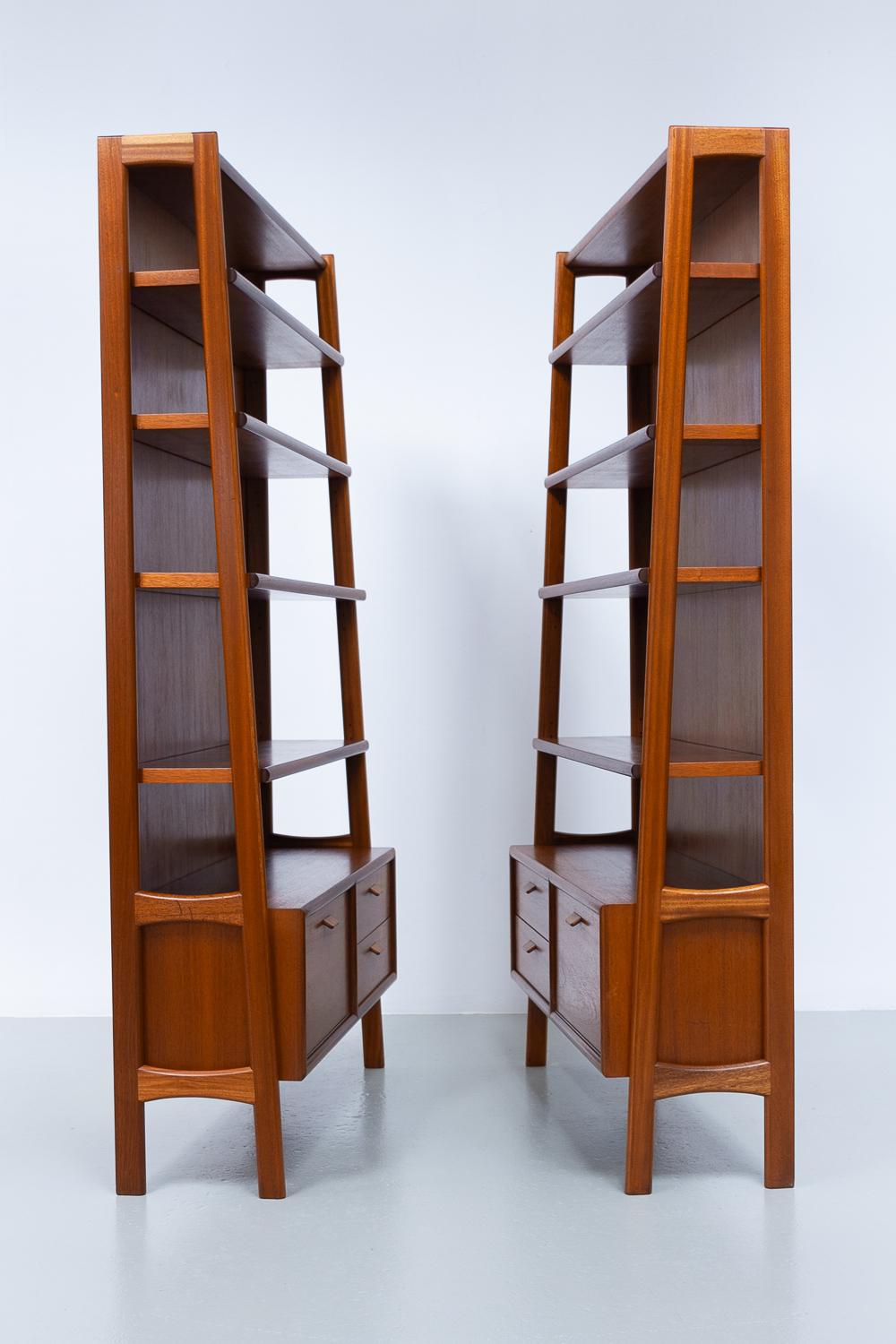 Scandinavian Mid-Century Modern 1960s elegant freestanding shelving units attributed to Danish architect Poul M. Volther. Manufactured in Denmark in the 1960s.

Opulent tapered design in a light golden mahogany, each with four height adjustable