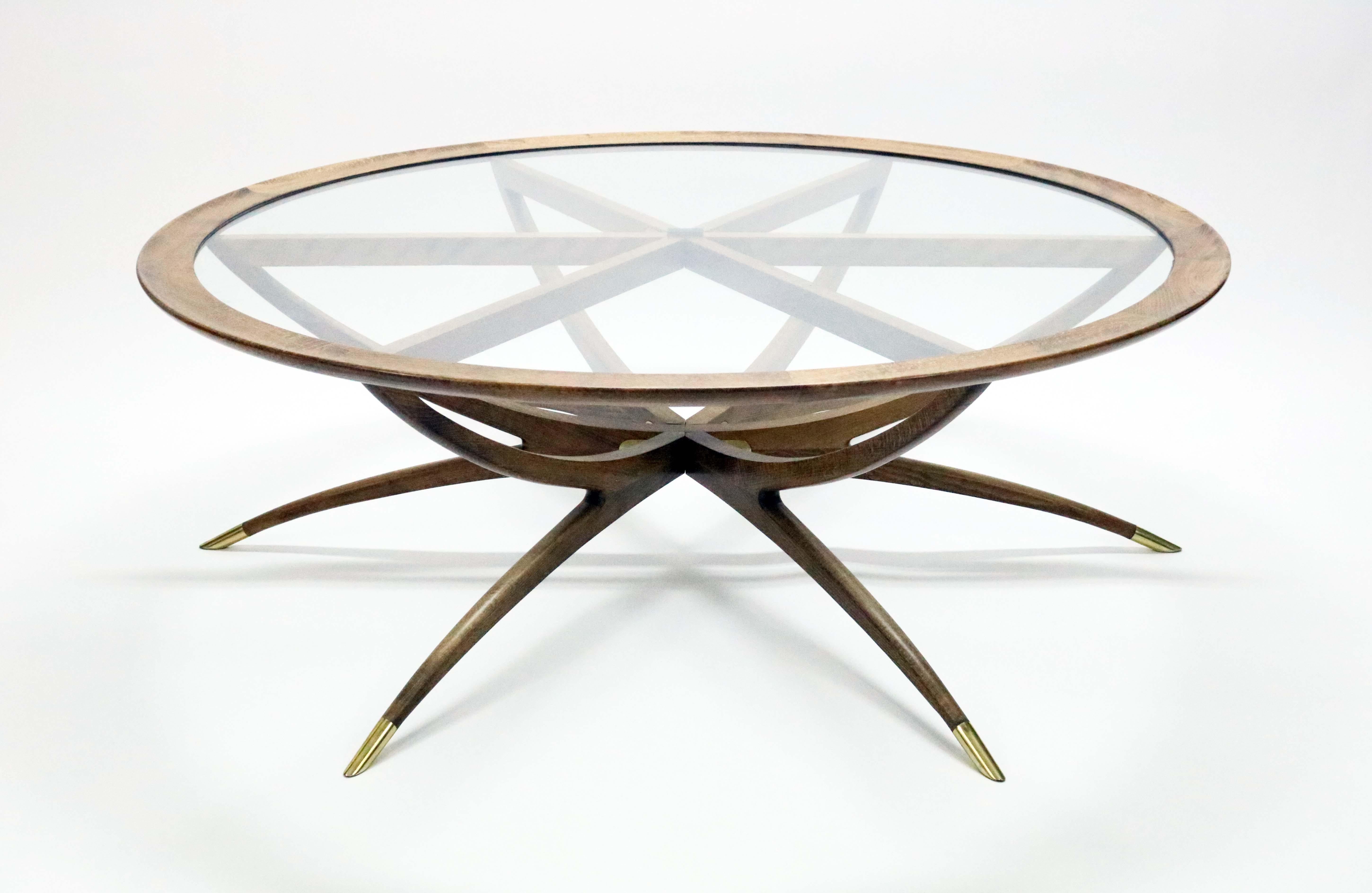 A captivating mahogany spider leg coffee table in the style of Carlo de Carli.

The glass top lifts off, and the base folds flat for storage or ease in moving.

Recently professionally refinished.