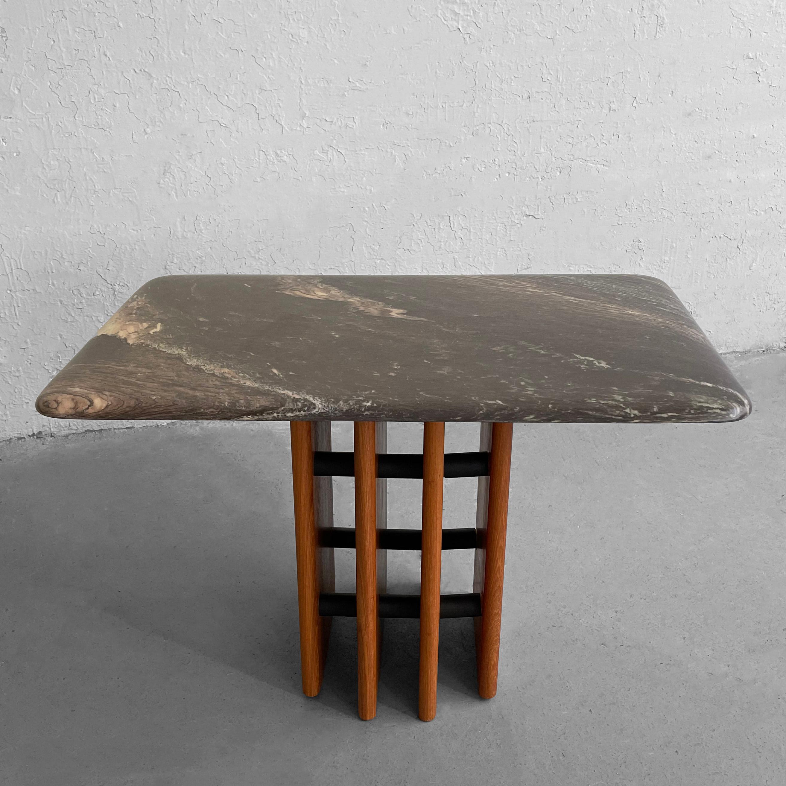 Interesting, Danish modern, side table attributed to the maker Marmorhuset features a black and beige grain marble top with a graduated teak paneled base with laminate bracing.