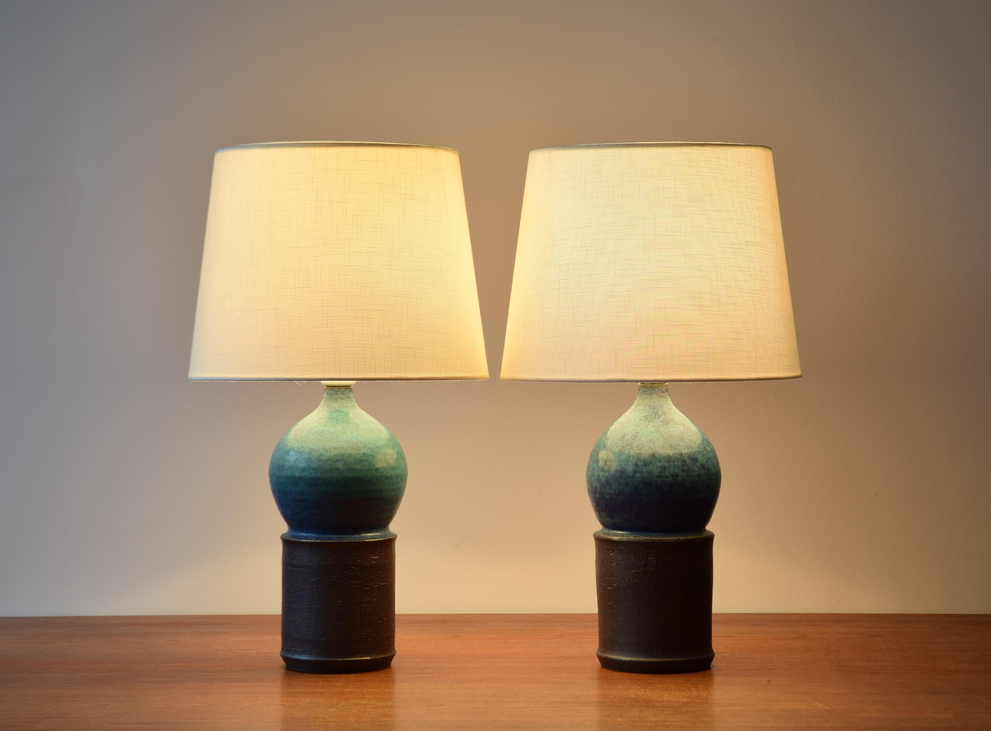 Pair of Danish midcentury sculptural table lamps by Marianne Starck for Michael Andersen & Søn made of turquoise blue glaze and dark brown clay.
Made circa 1960s. 

Included are new lampshades designed in Denmark. They are made of woven fabric