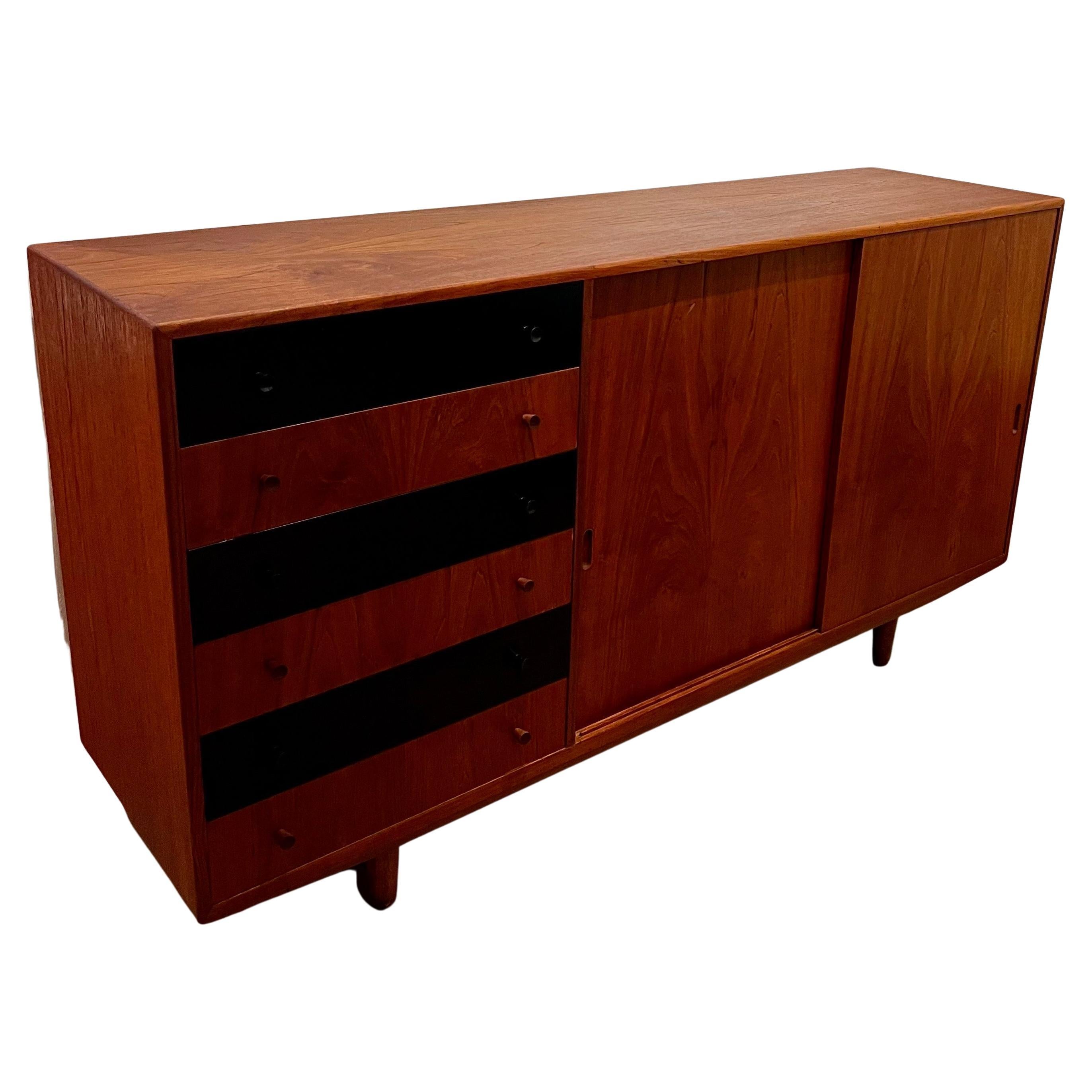 Beautiful massive large Danish teak credenza with solid oak tapered legs, dovetail drawers triple shelves, double sliding doors freshly refinished with 6 side drawers, 3 black lacquered beautiful storage piece.